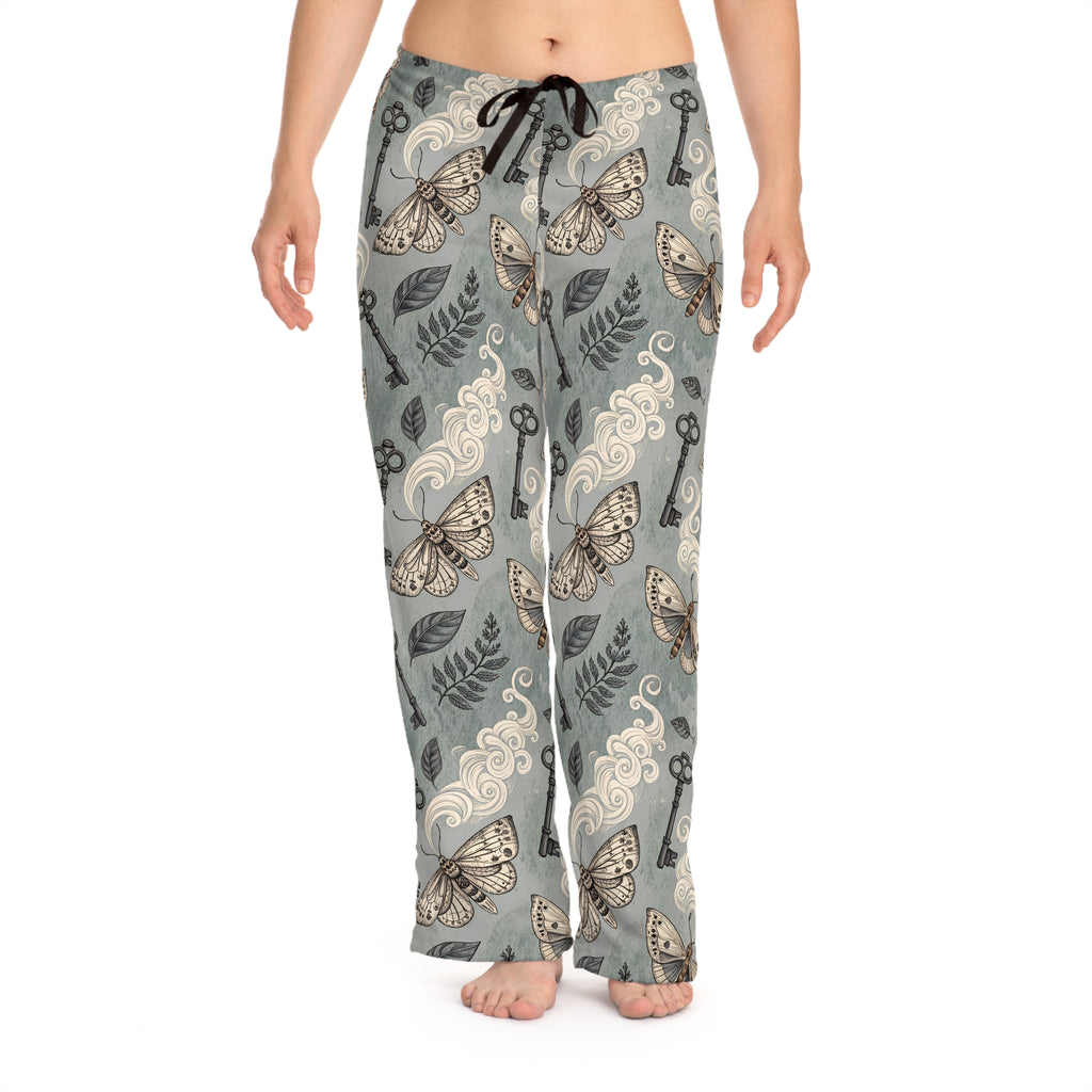 Moths and key patterned pajama pants on a white background