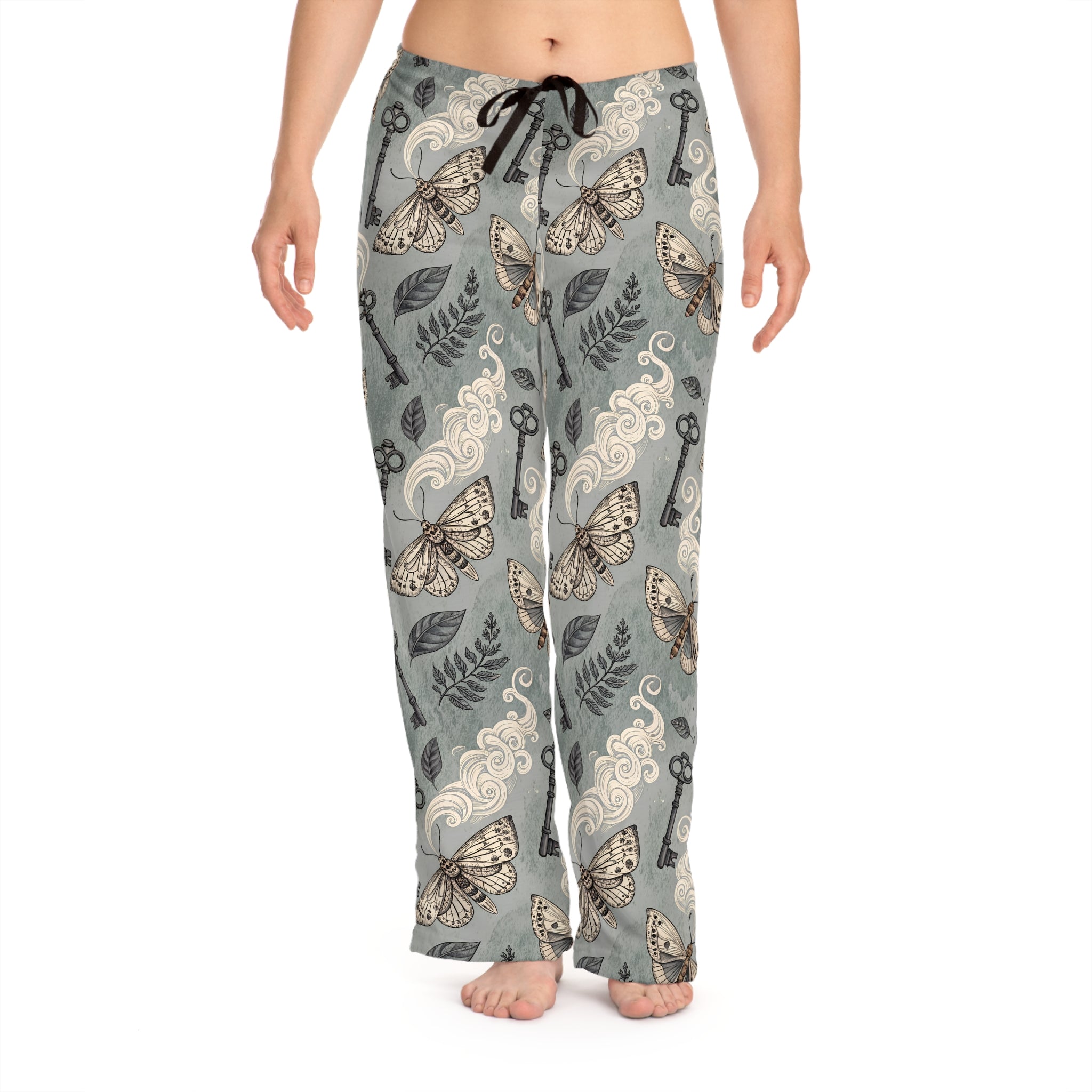 Moths and key patterned pajama pants on a white background