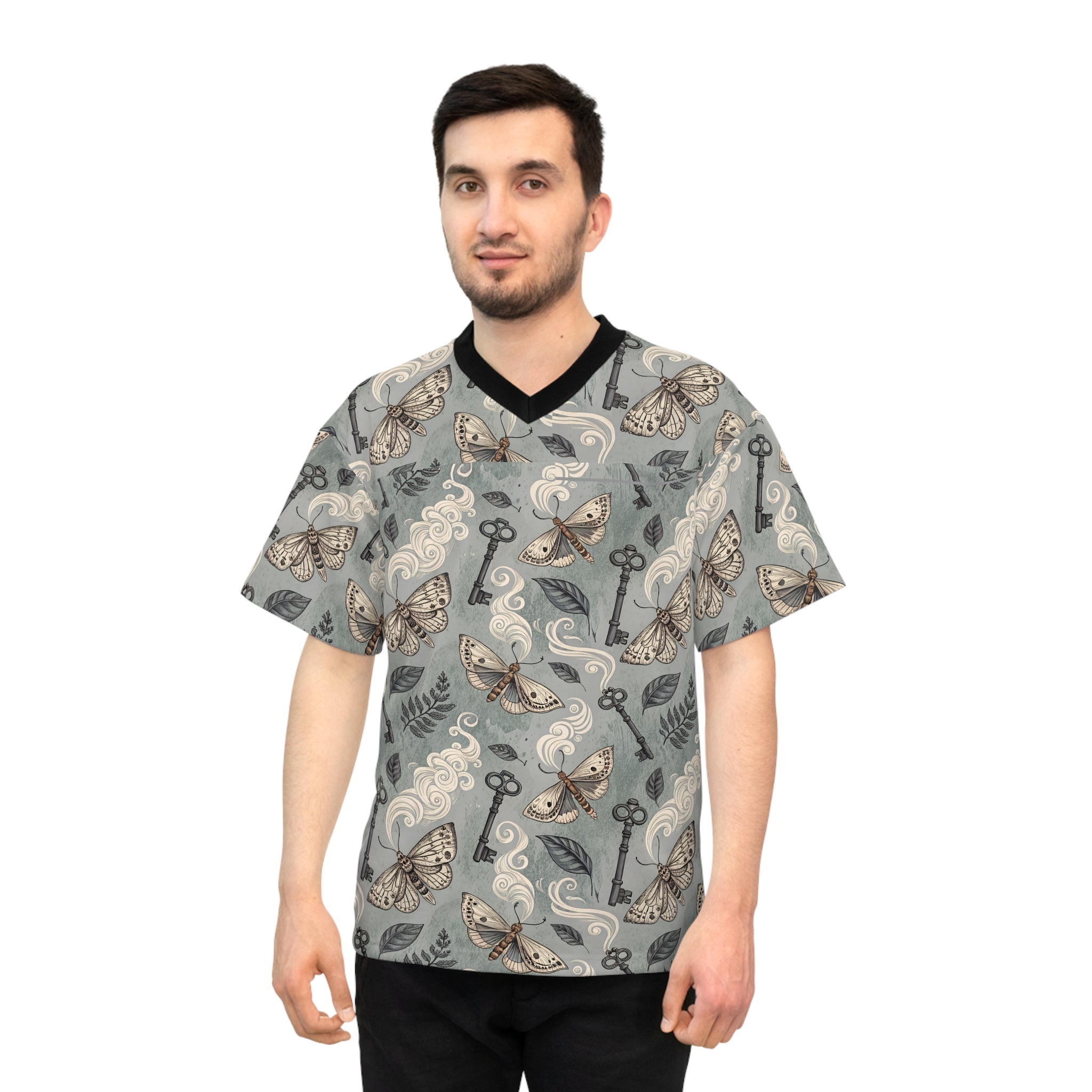 Man wearing a patterned shirt with keys and moths on a white background