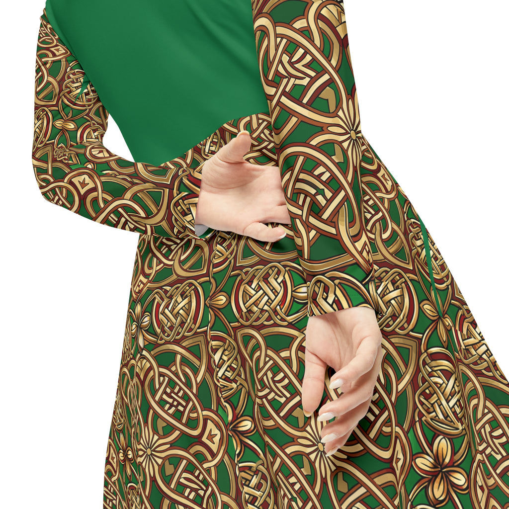 Green and gold patterned dress on model from back with hands together on white background.