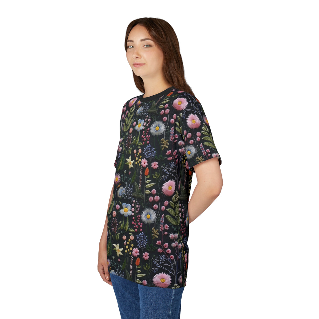 Woman wearing a dark t-shirt with floral pattern on a white background