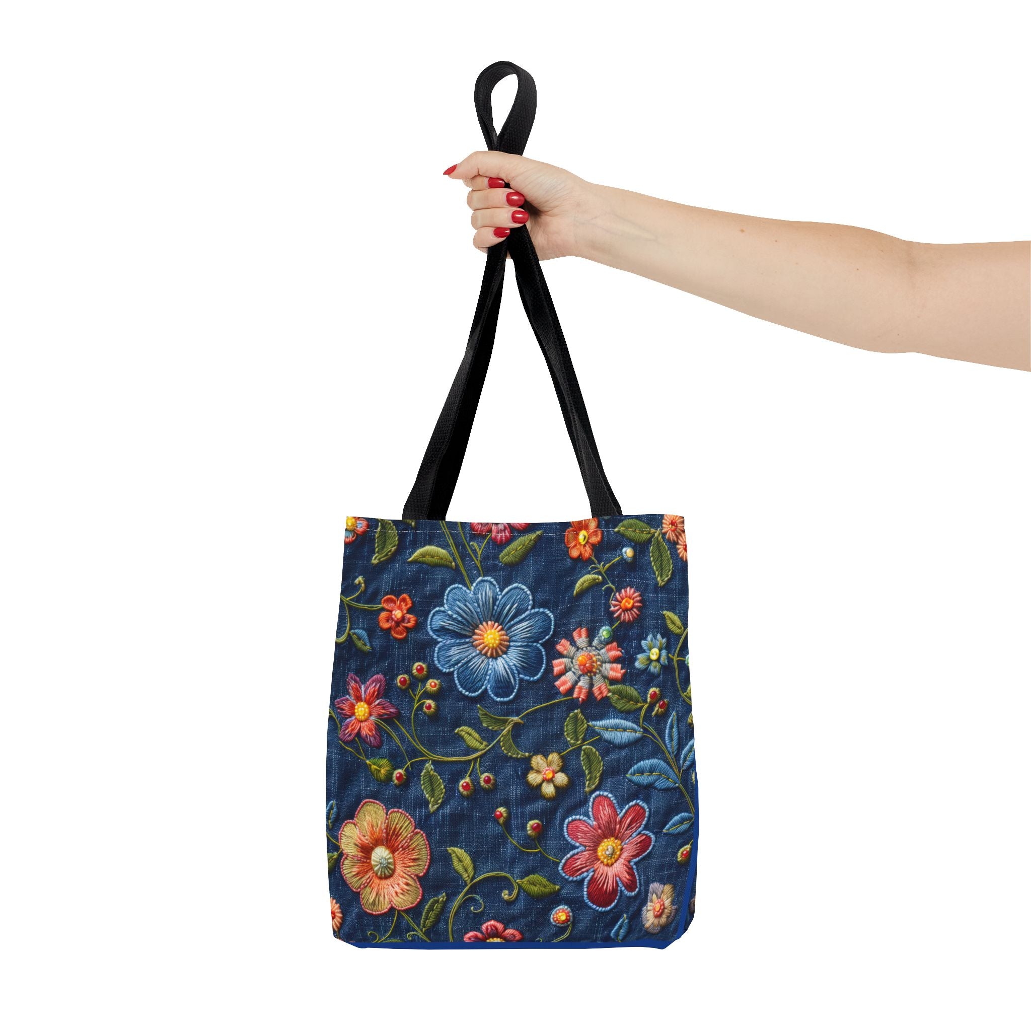 Tote bag with floral design held by a hand on a white background
