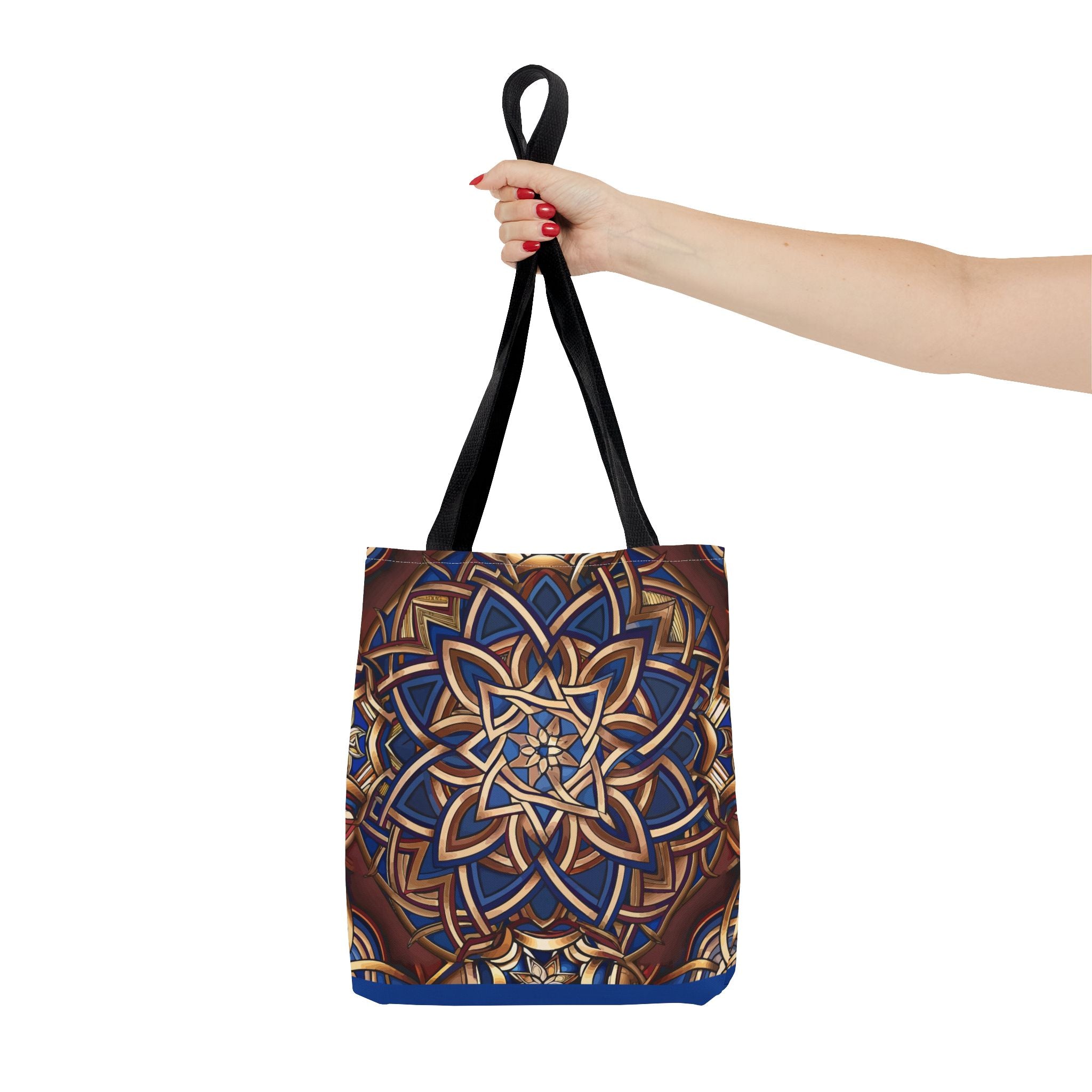 Tote bag with a Celtic design held by a hand on a white background