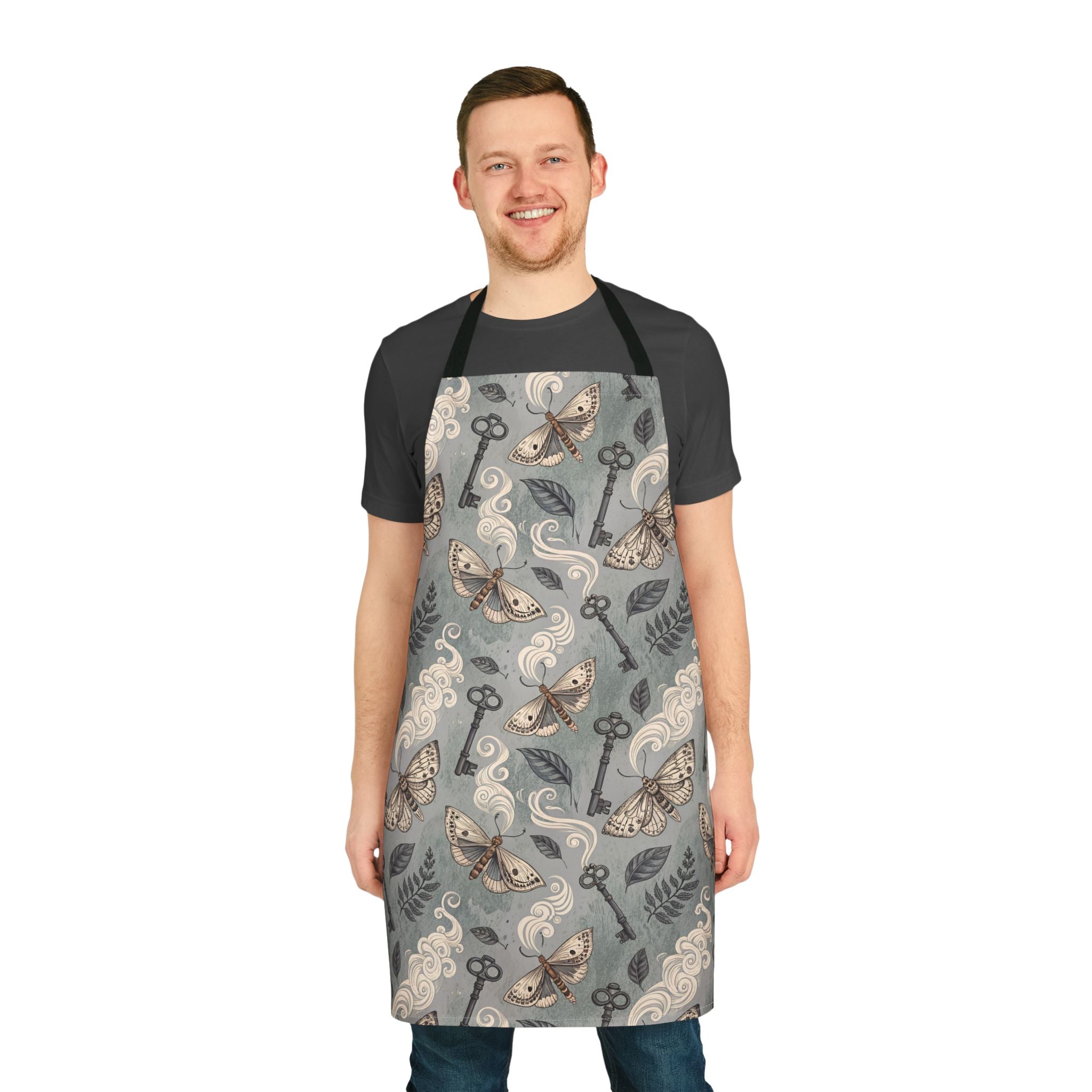 Man wearing a gray apron with decorative patterns on a white background