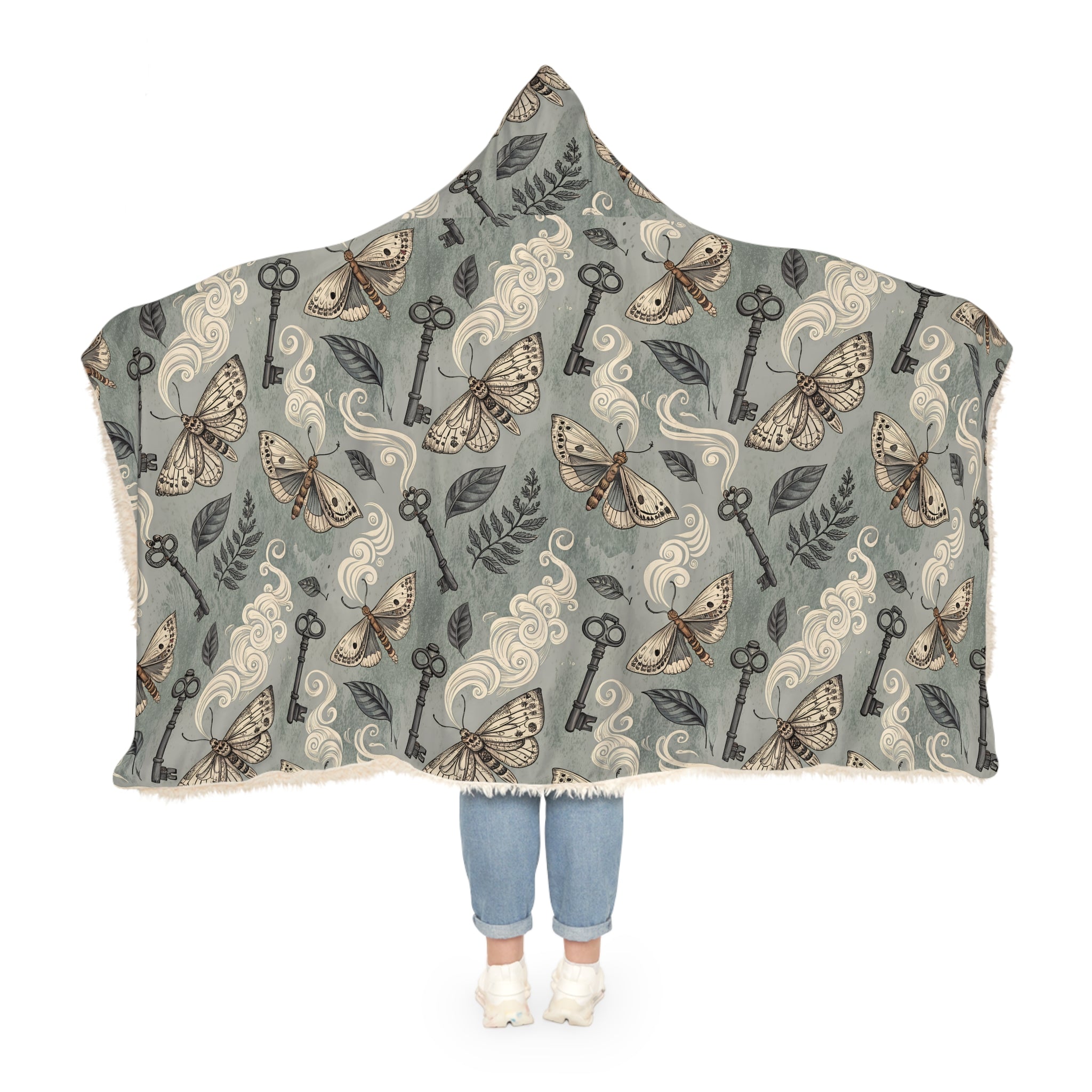 Hooded blanket with moth and key pattern on a white background