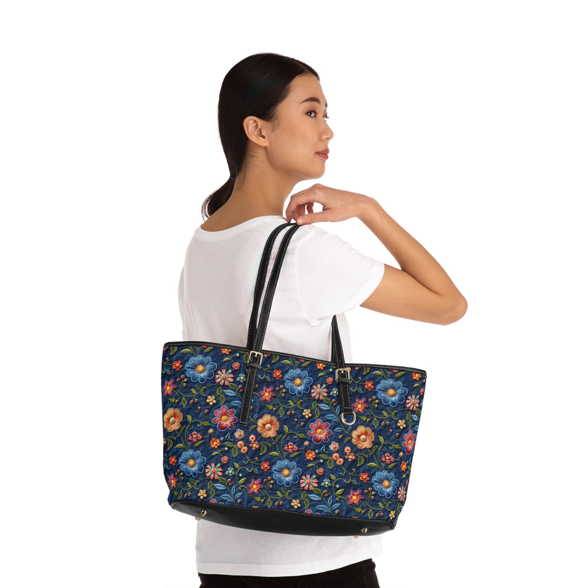Woman holding a floral-patterned tote bag against a white background