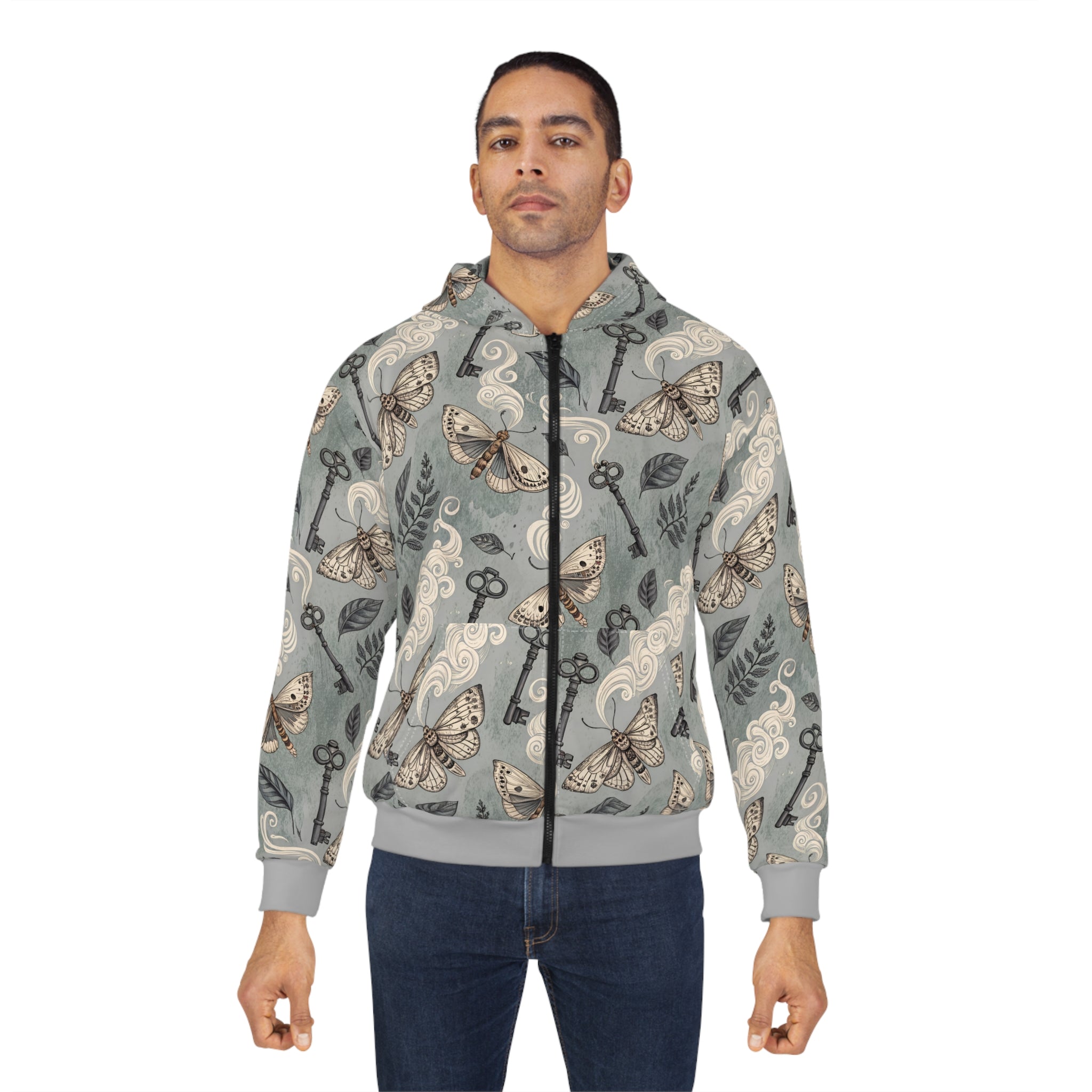 Man wearing a gray hoodie with moth and key pattern on a white background