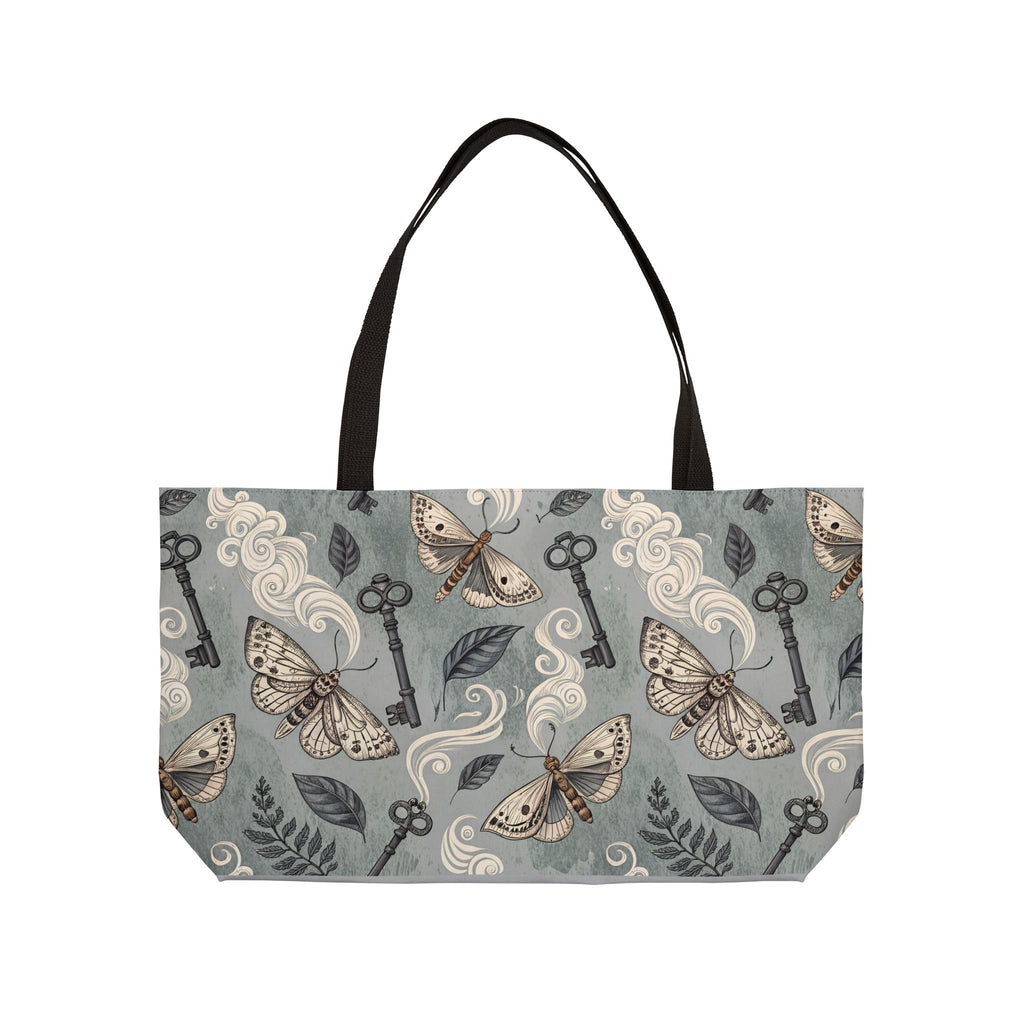 Tote bag with moth and key pattern on a gray background