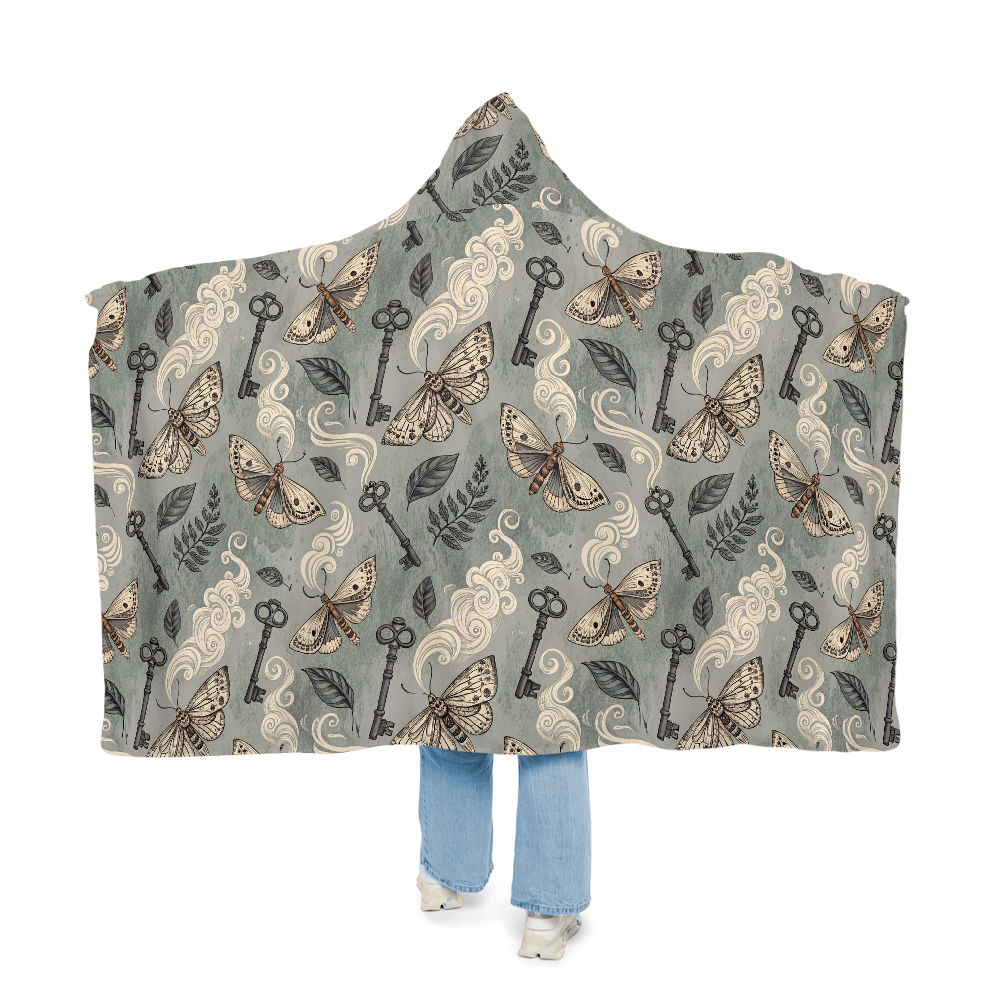 Hooded blanket with moth and key pattern on a white background