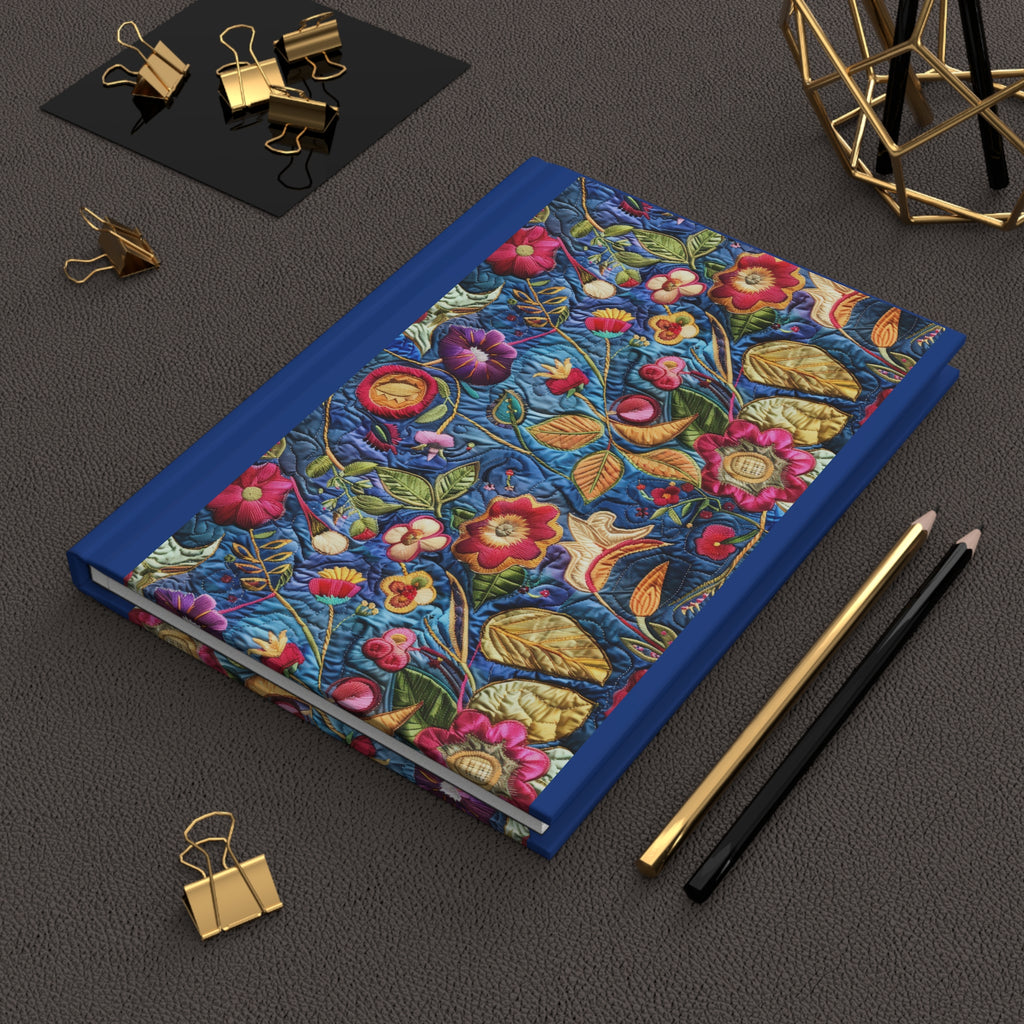 Floral notebook with decorative elements on a dark surface with stationery items.