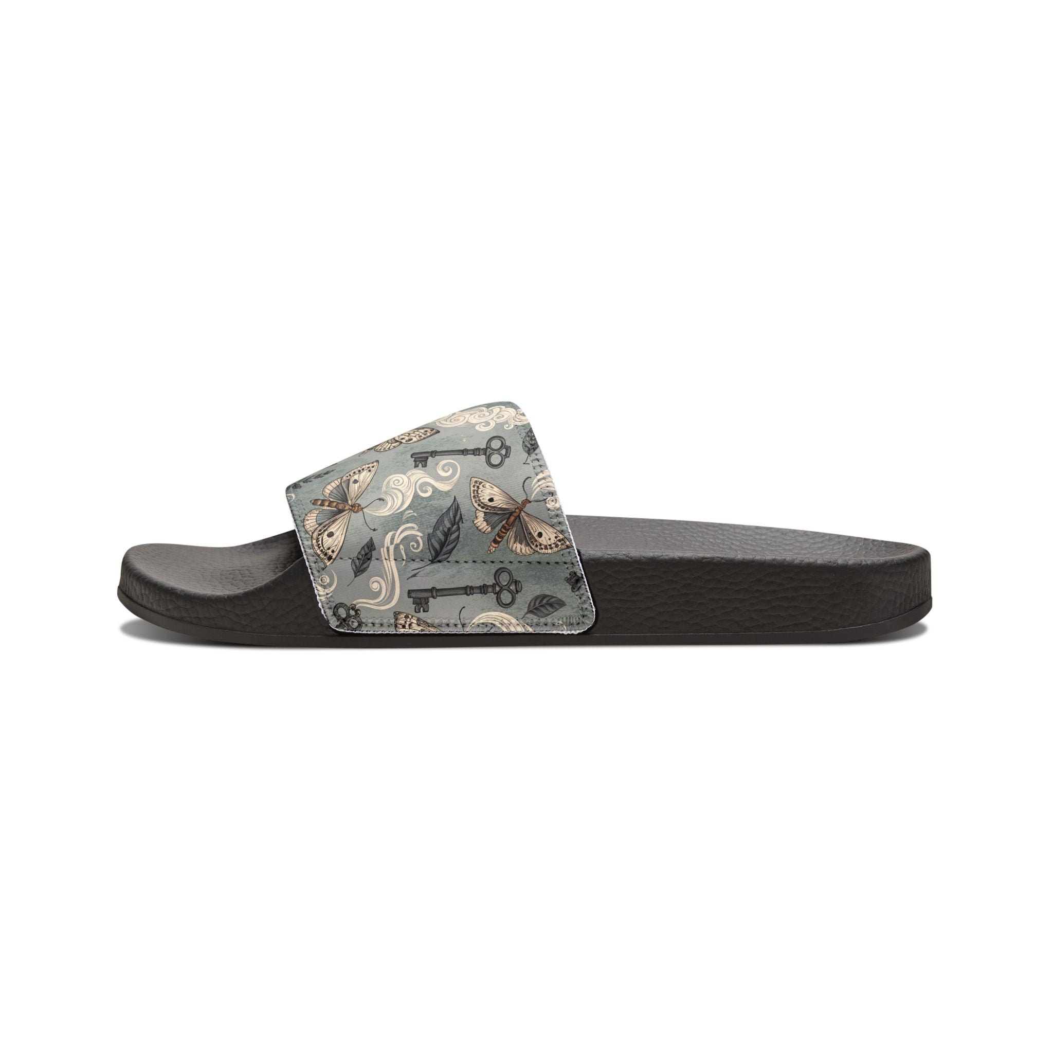 Black slide sandal with a patterned strap on a white background