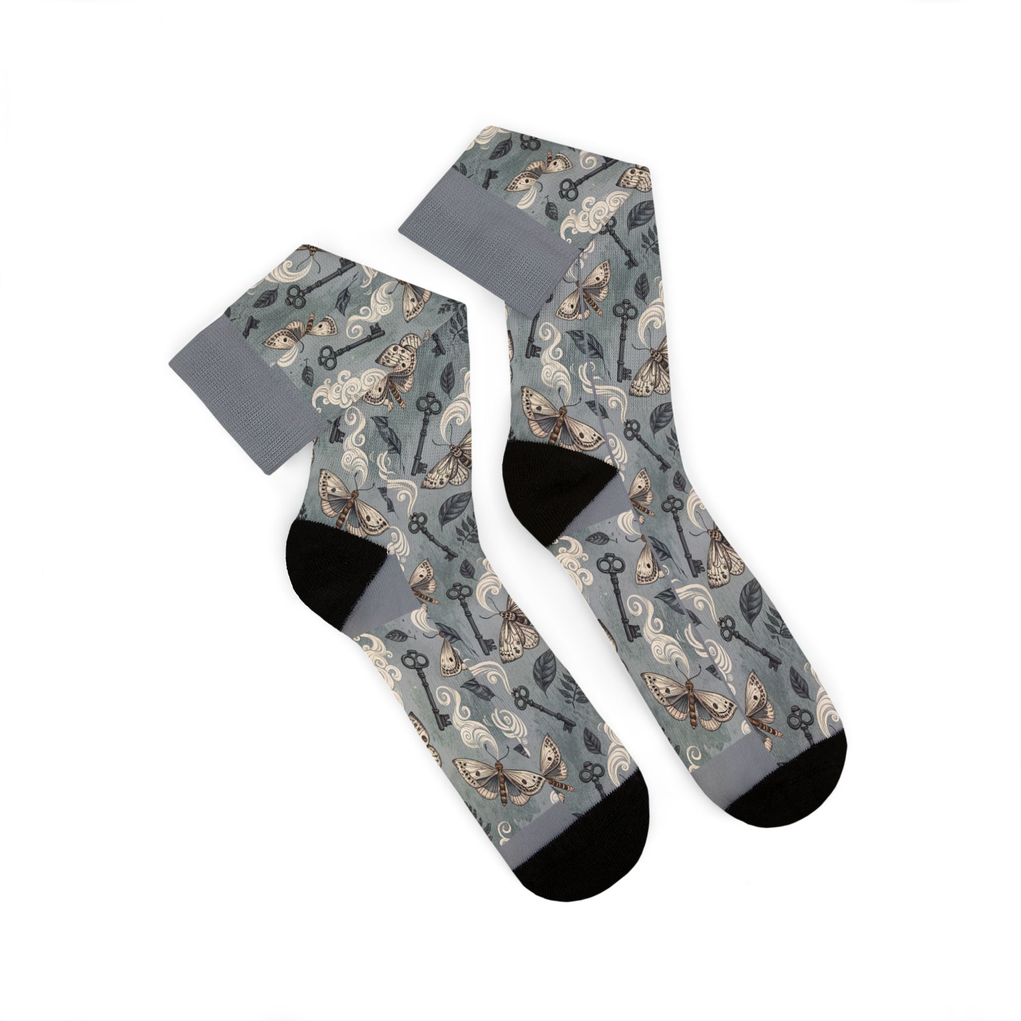 Gray socks with a pattern of keys and moths on a white background