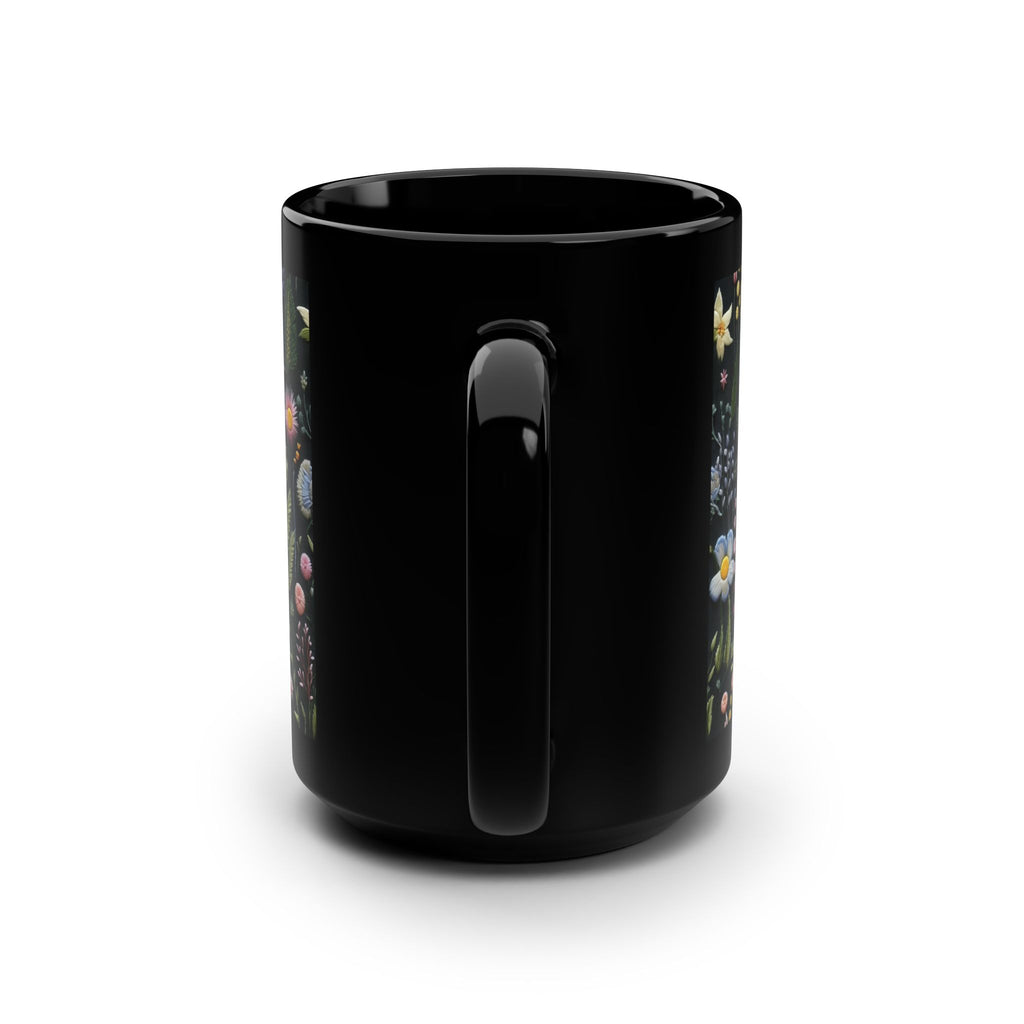 Black mug with colorful designs on a white background