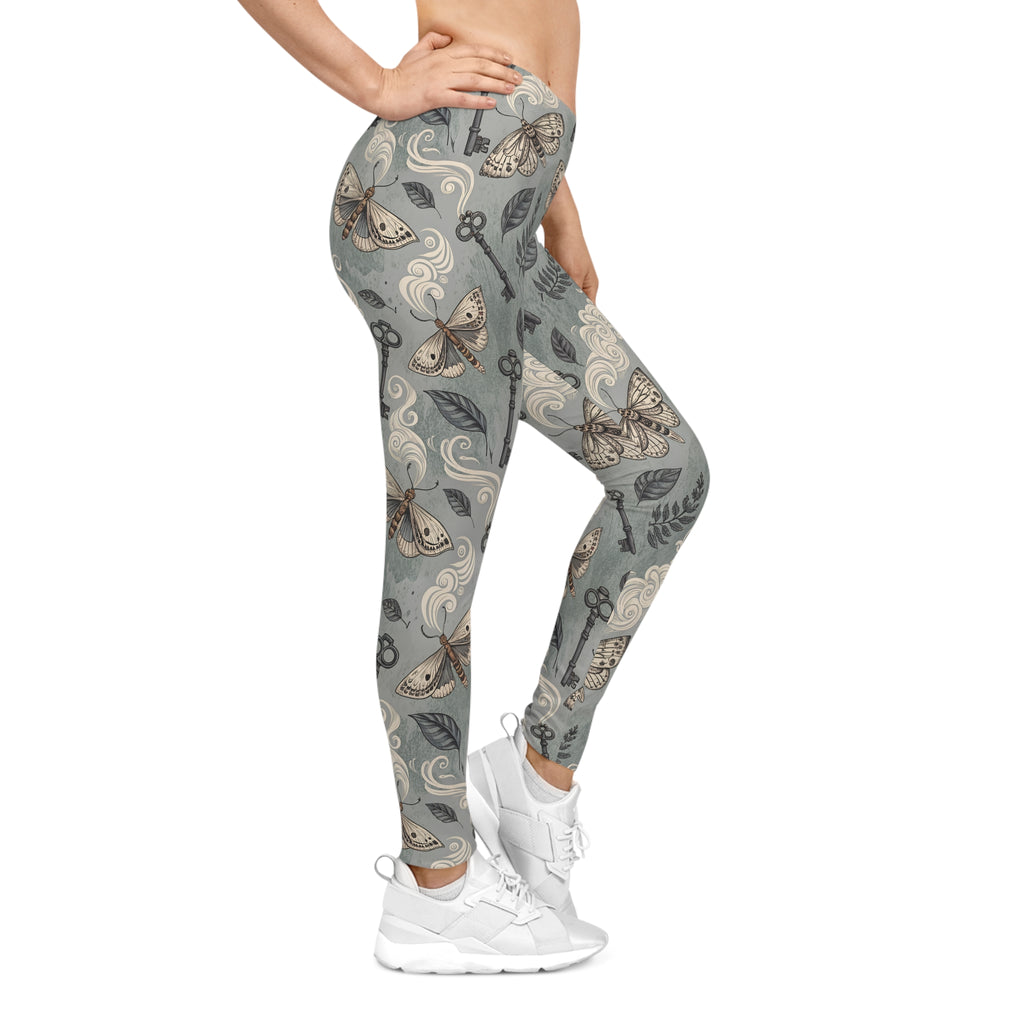 Leggings with moth & key pattern worn by a model on a white background
