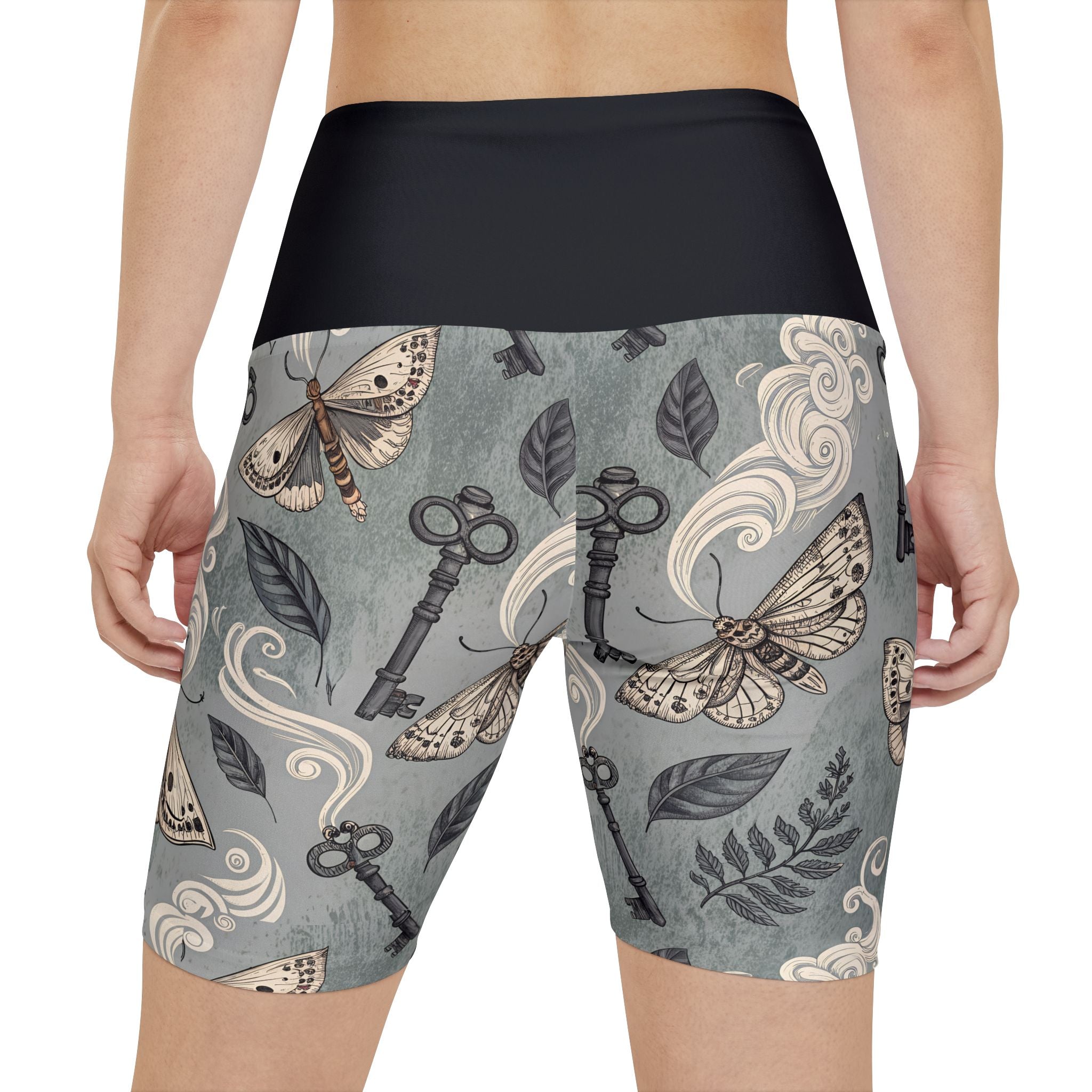 Shorts with vintage-style key and moth pattern on a gray background
