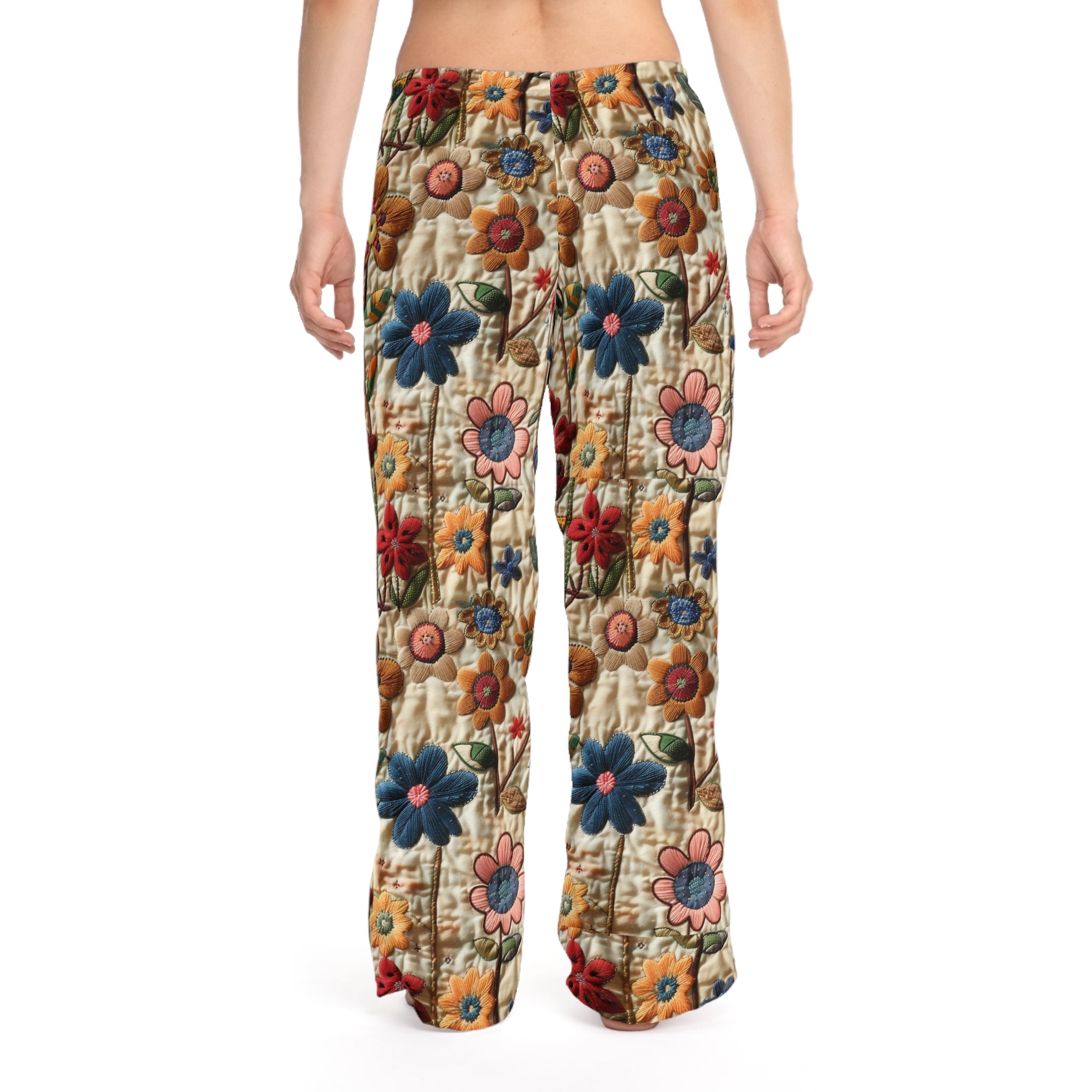 Floral patterned pants worn by a person on a white background