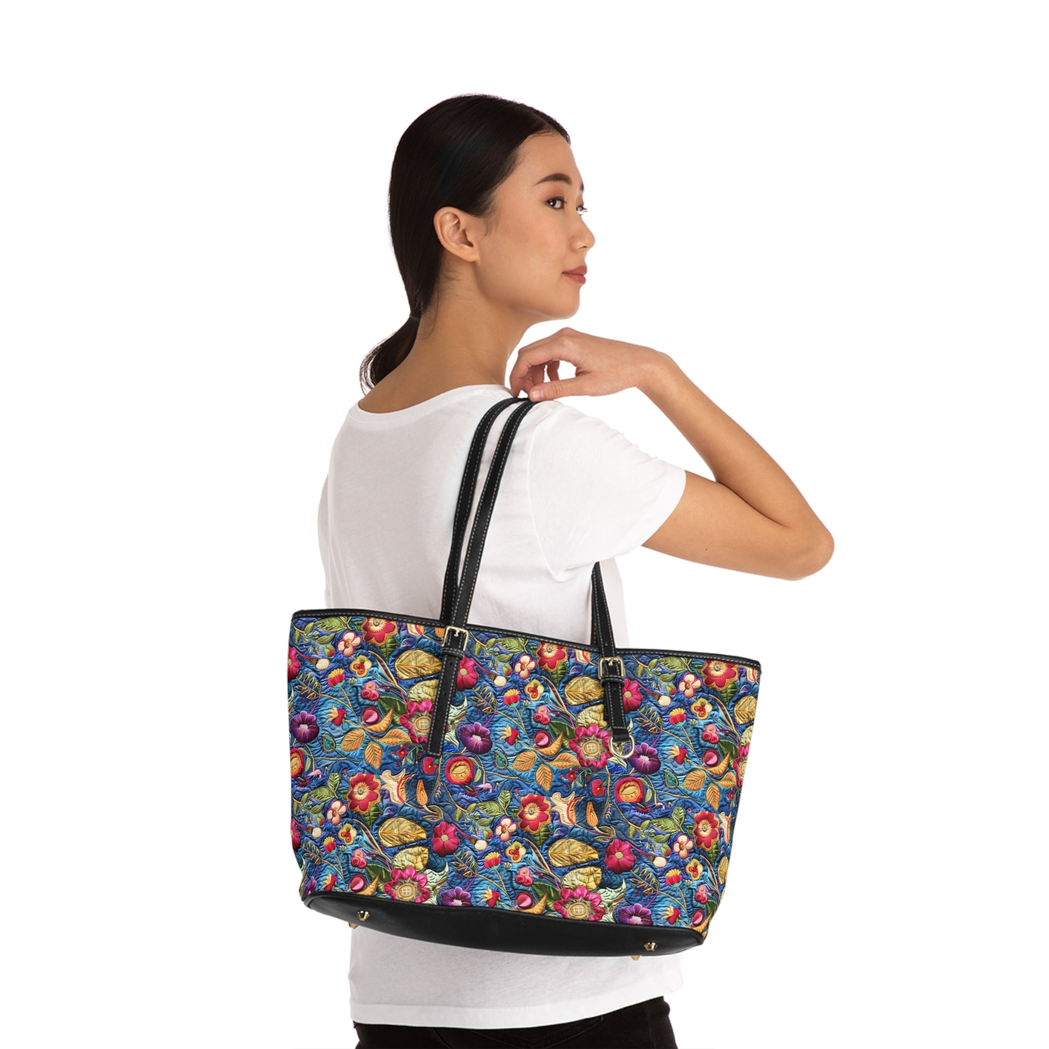 Woman holding a colorful floral-patterned tote bag against a white background
