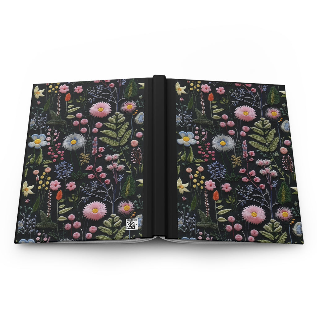Open notebook with floral design on a white background