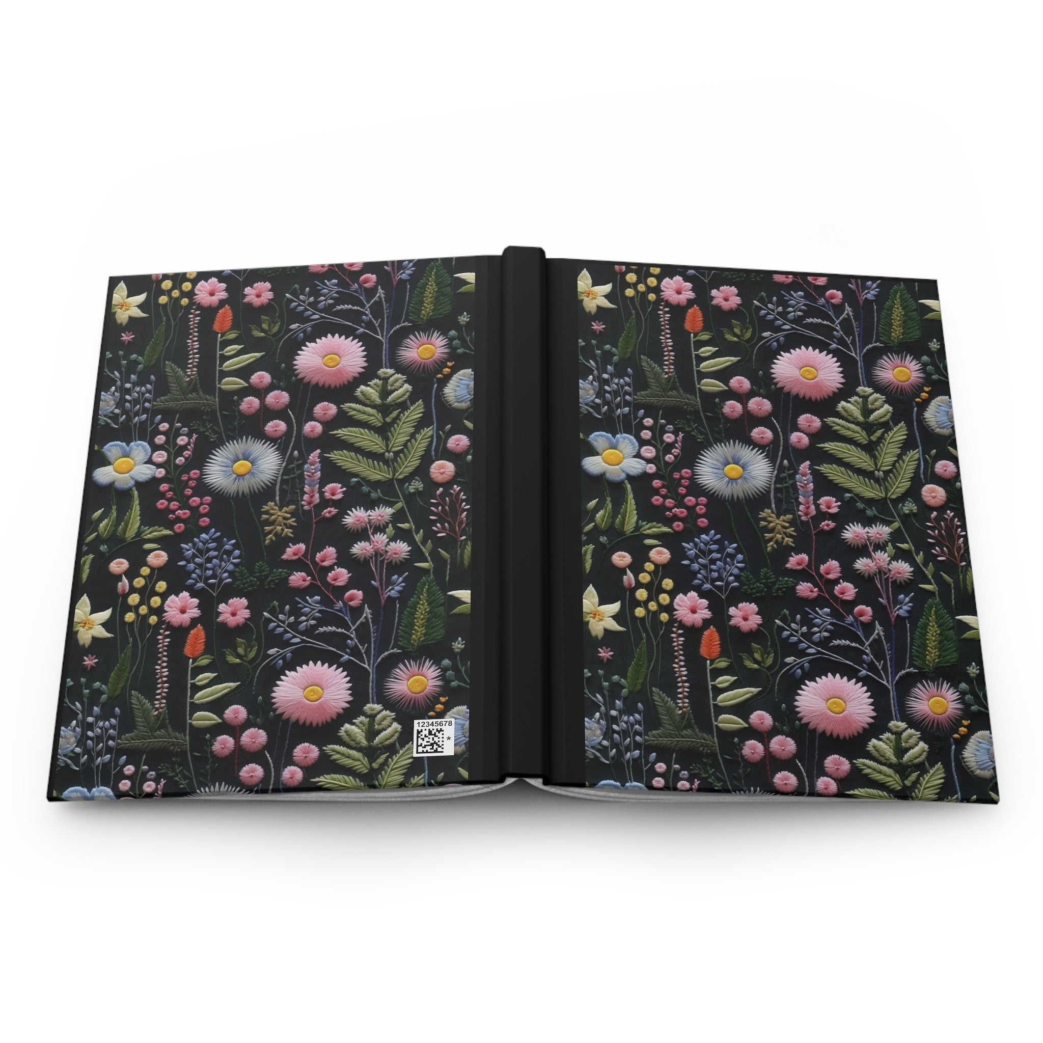 Open notebook with floral design on a white background
