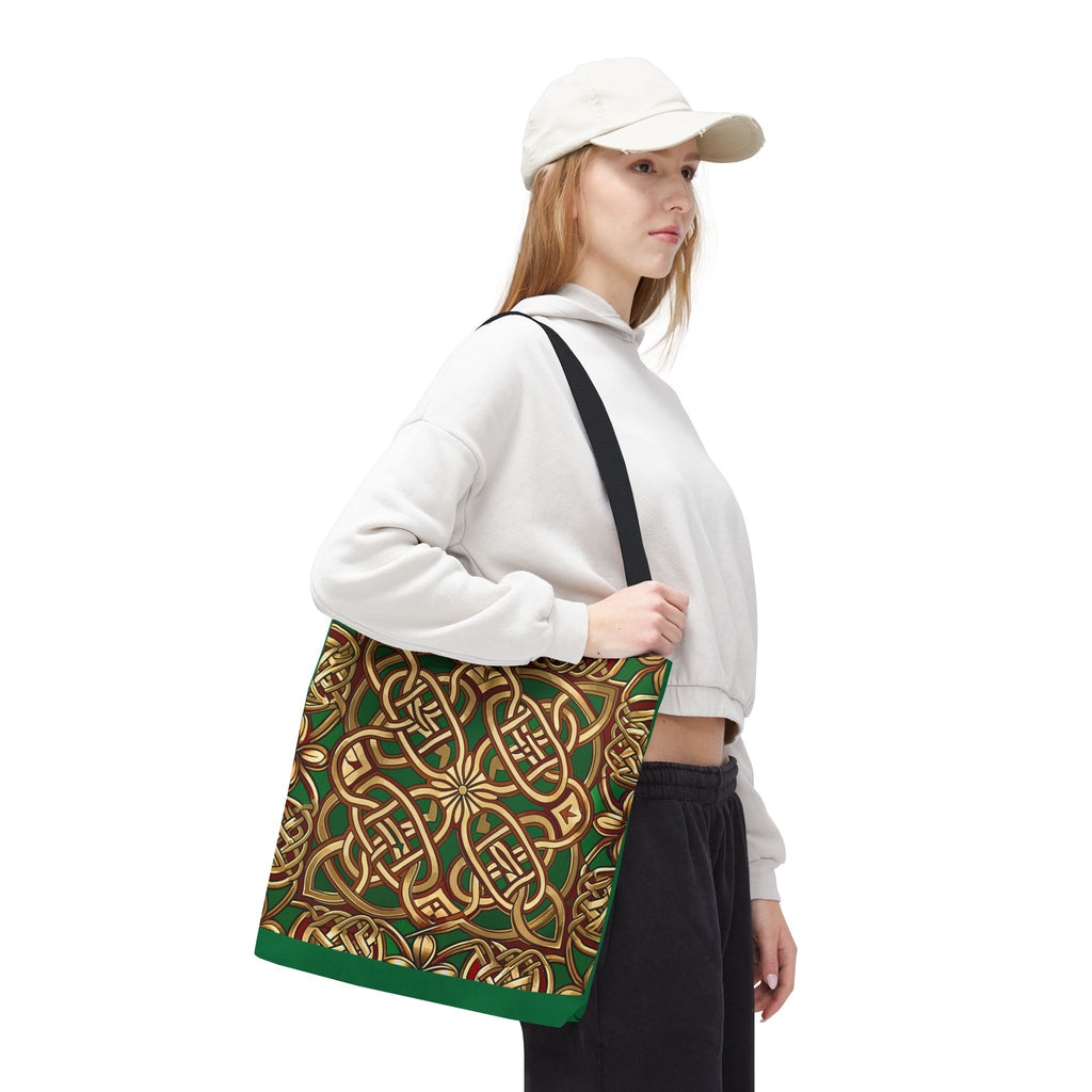 Person holding a green and gold patterned bag against a white background