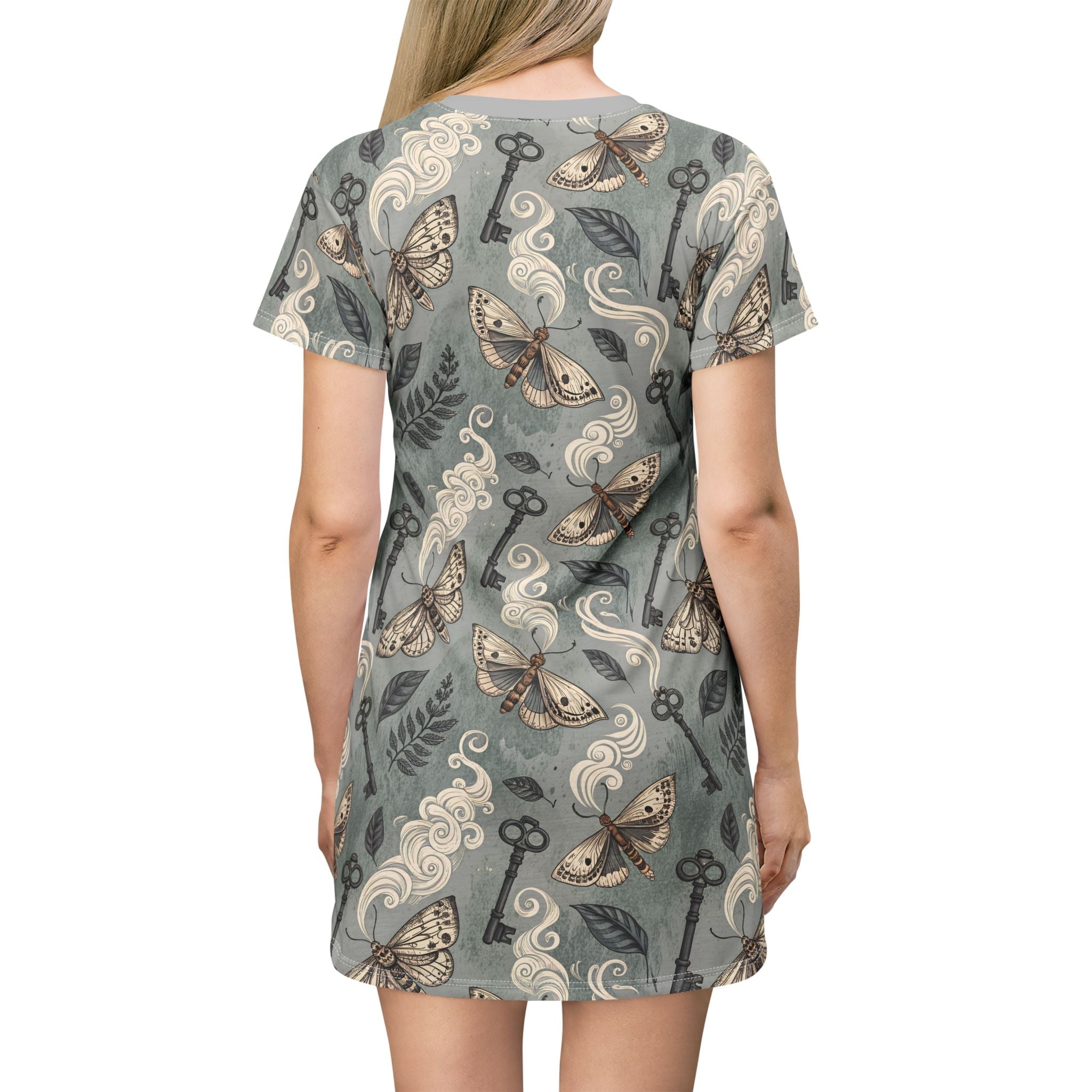 Woman wearing a patterned dress with moths and keys on a plain background