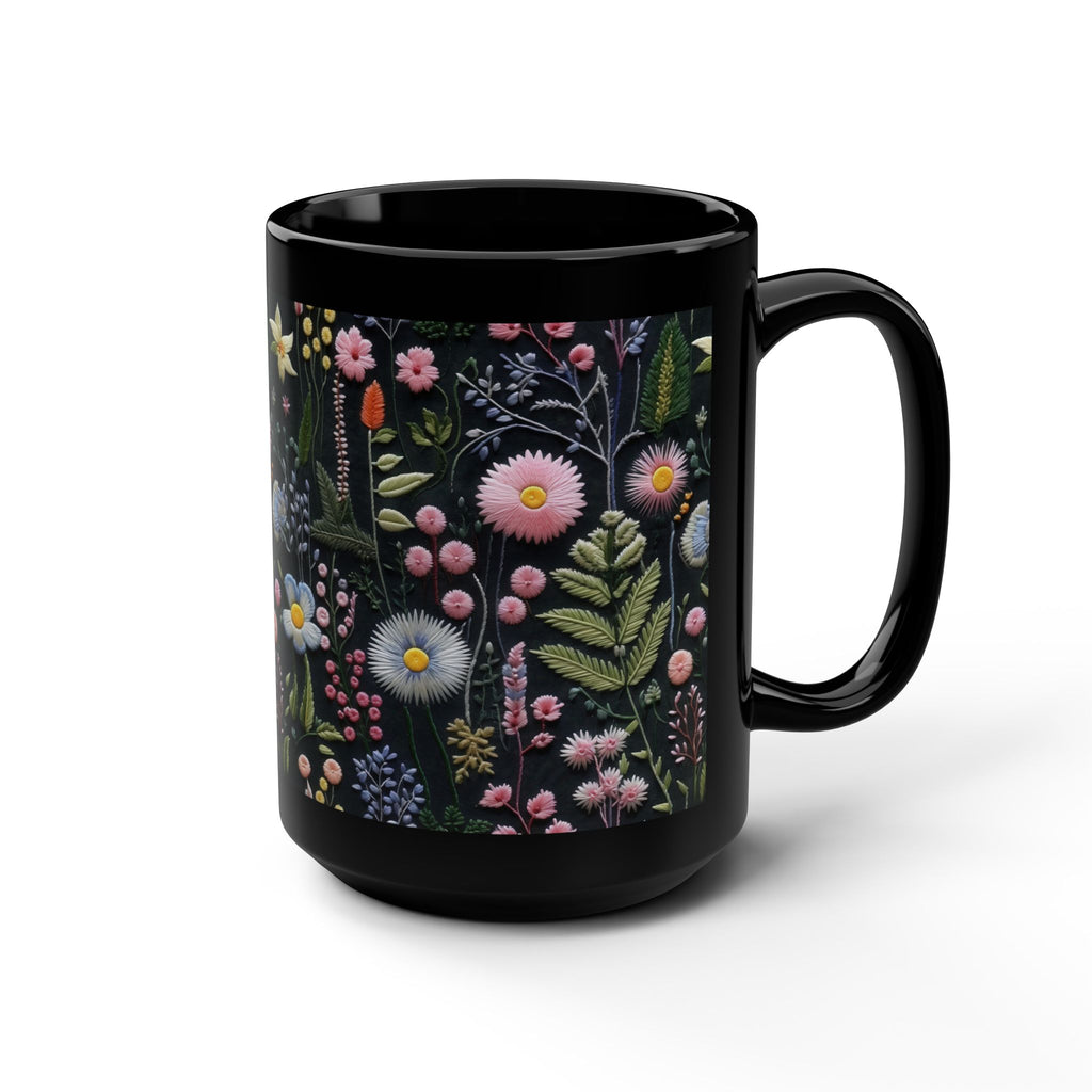 Black mug with a floral design on a white background.