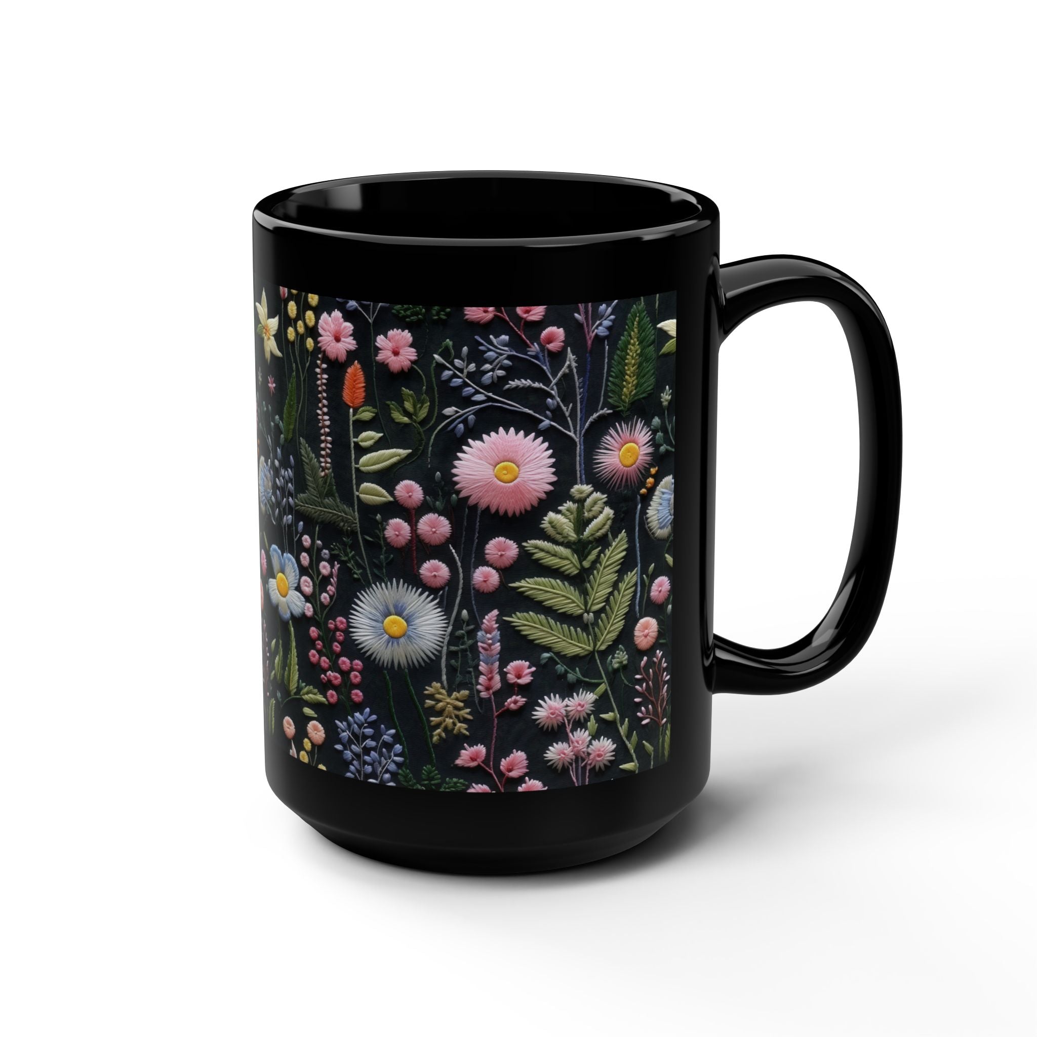 Black mug with a floral design on a white background.