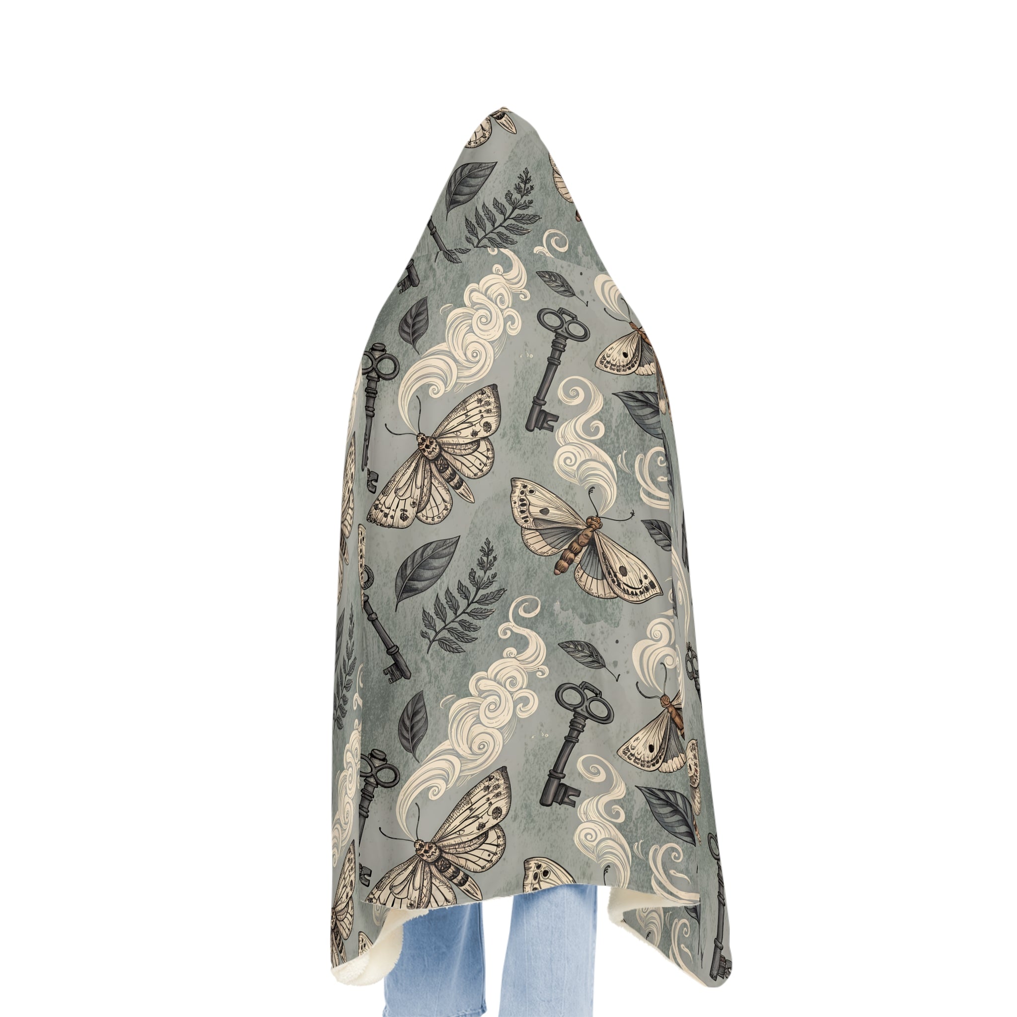 Hooded blanket with moth and key pattern on a white background
