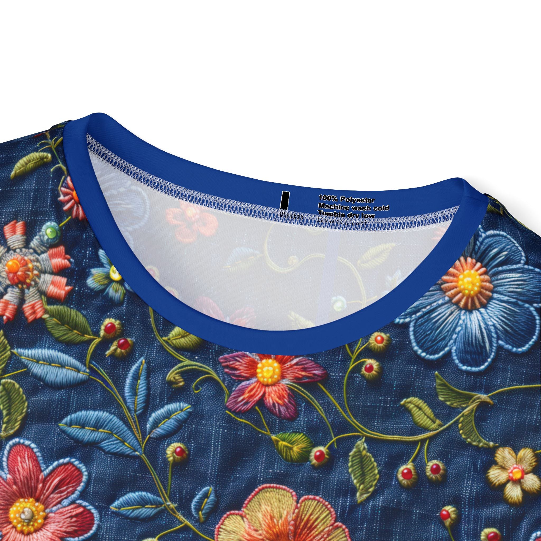 Close-up of Embroidered floral design on a garment with a blue neckline.