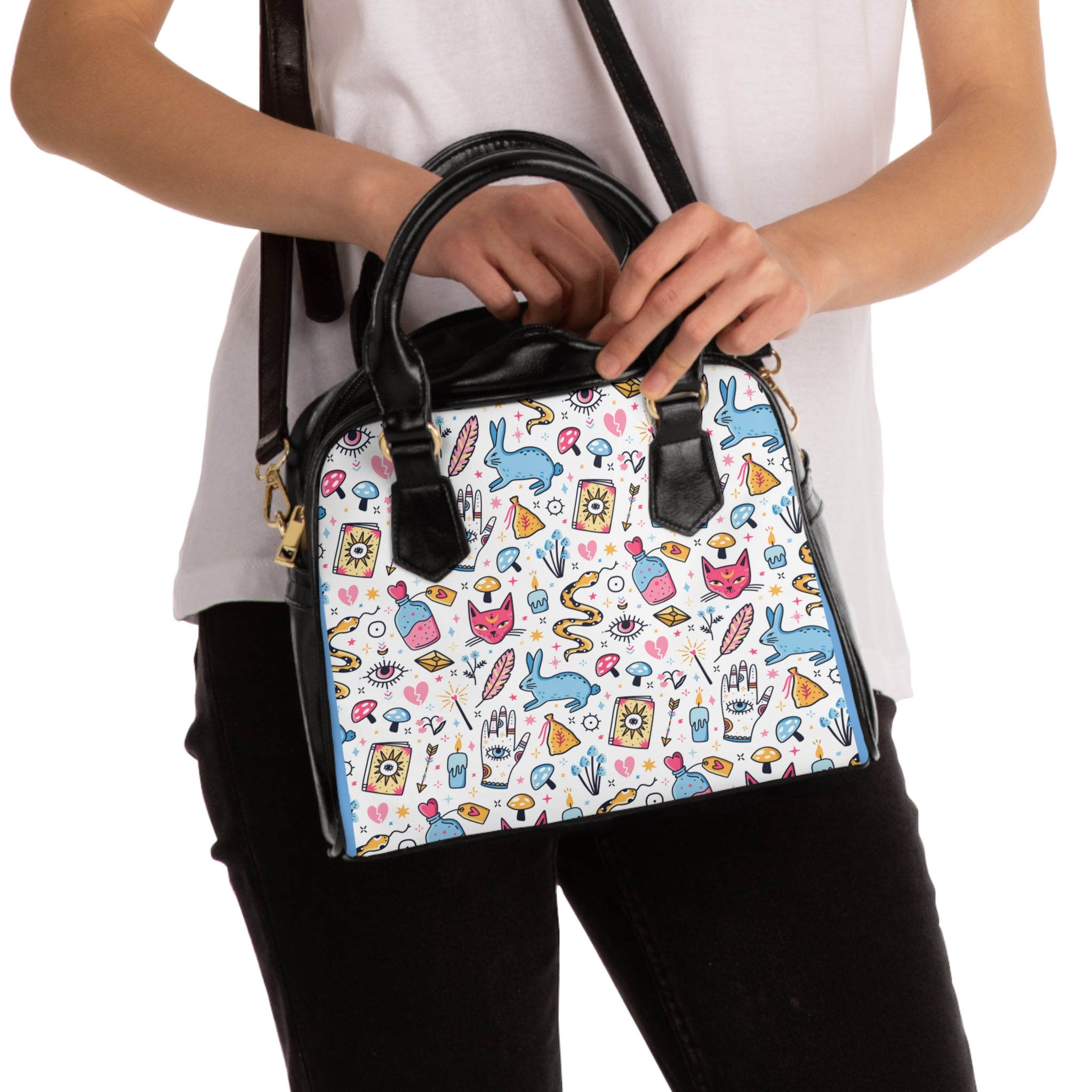 Handbag with colorful pattern held by a person against a white background