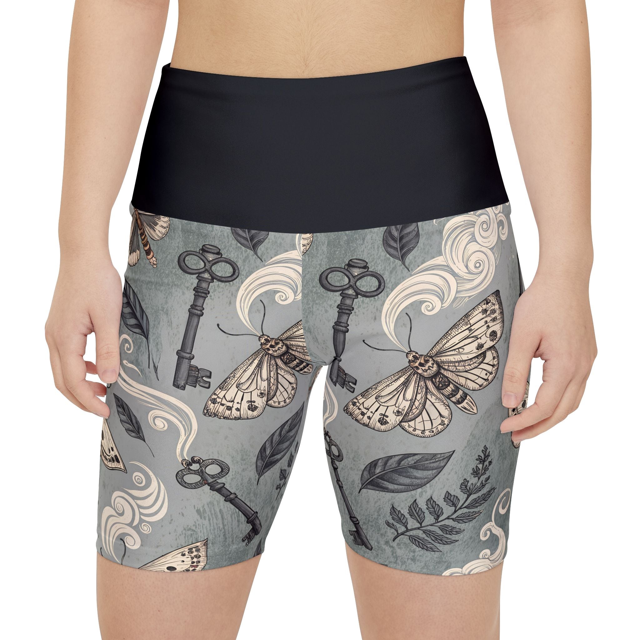 Biker shorts with moth and key pattern on a gray background