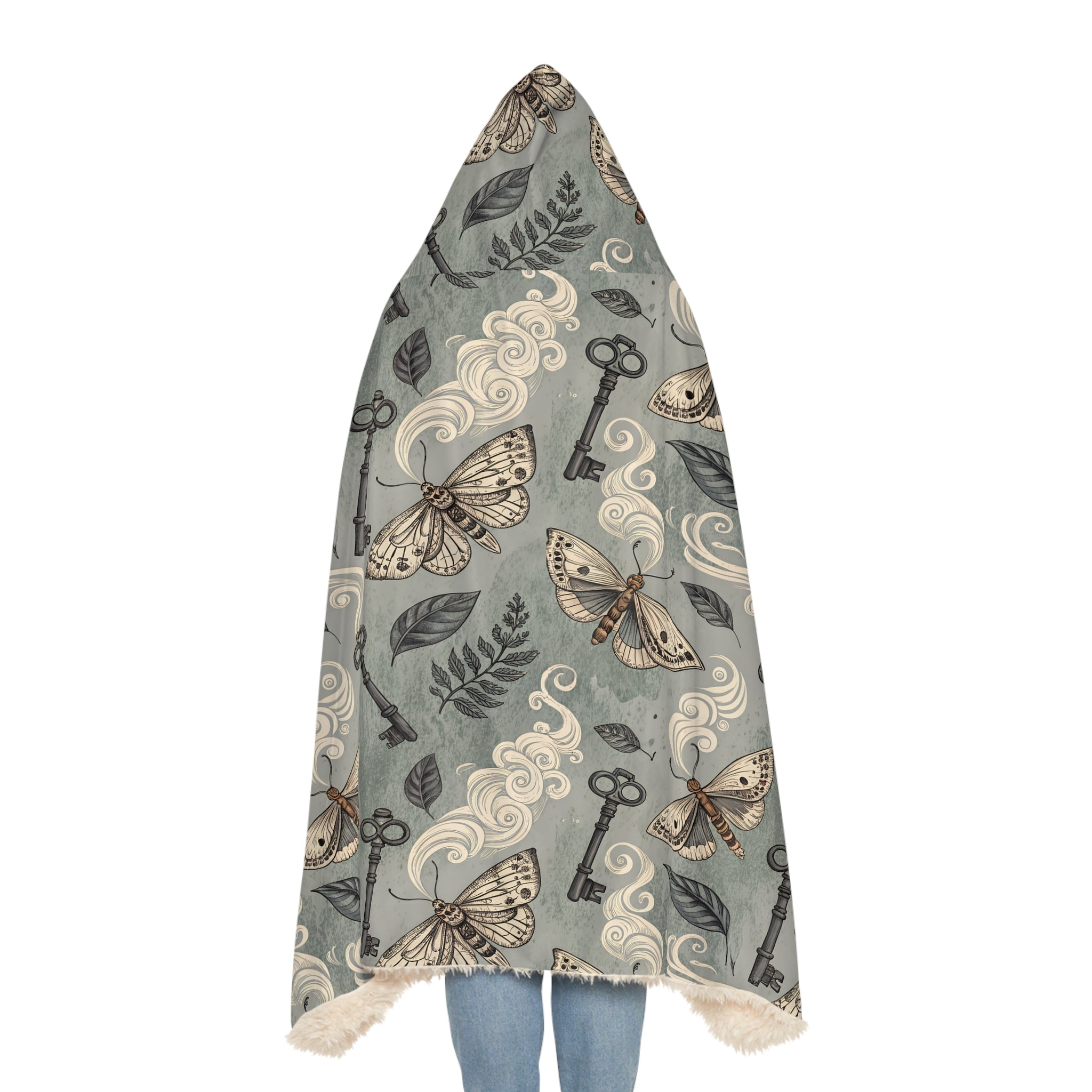 Hooded blanket with moth and key pattern on a white background