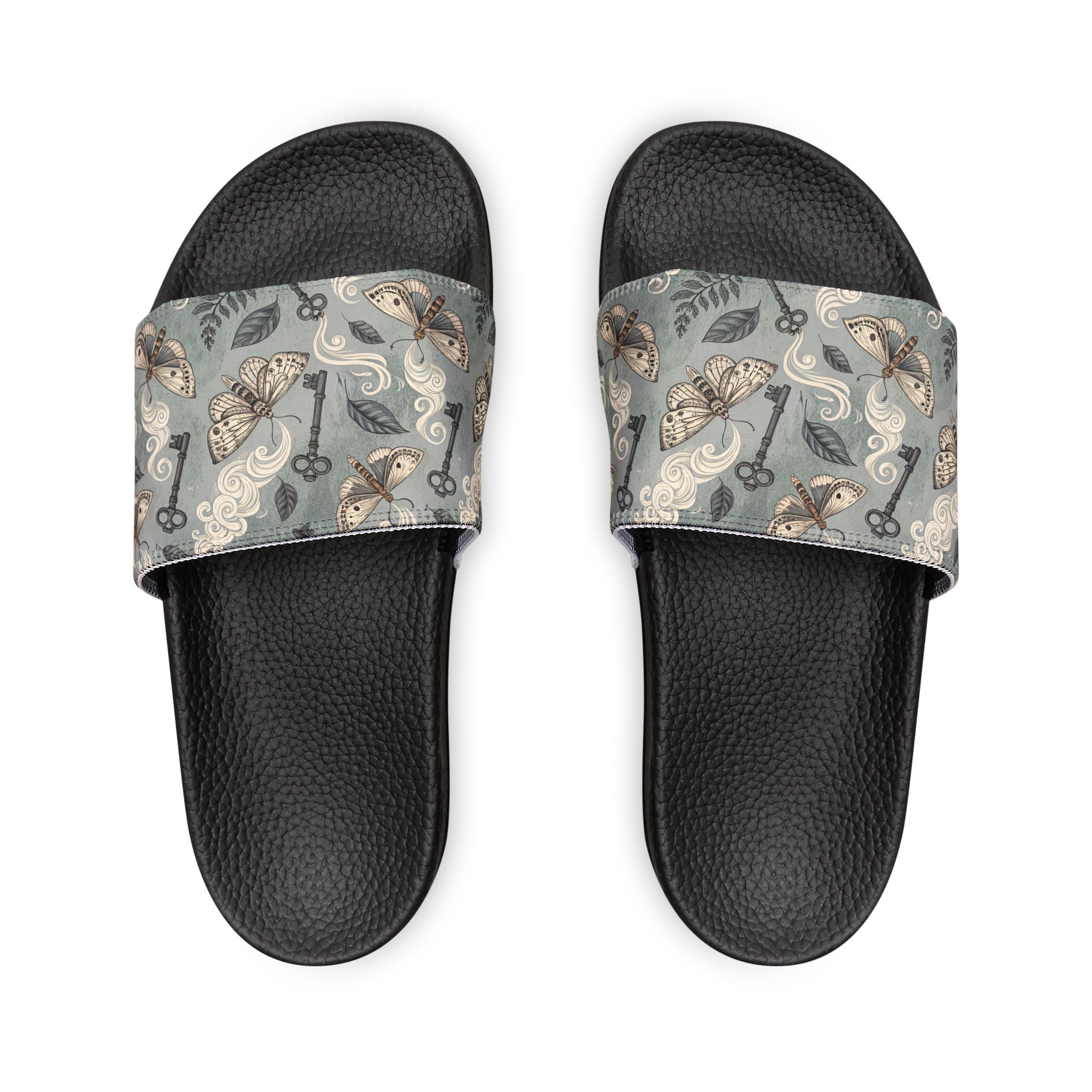 Black slides with patterned straps on a white background