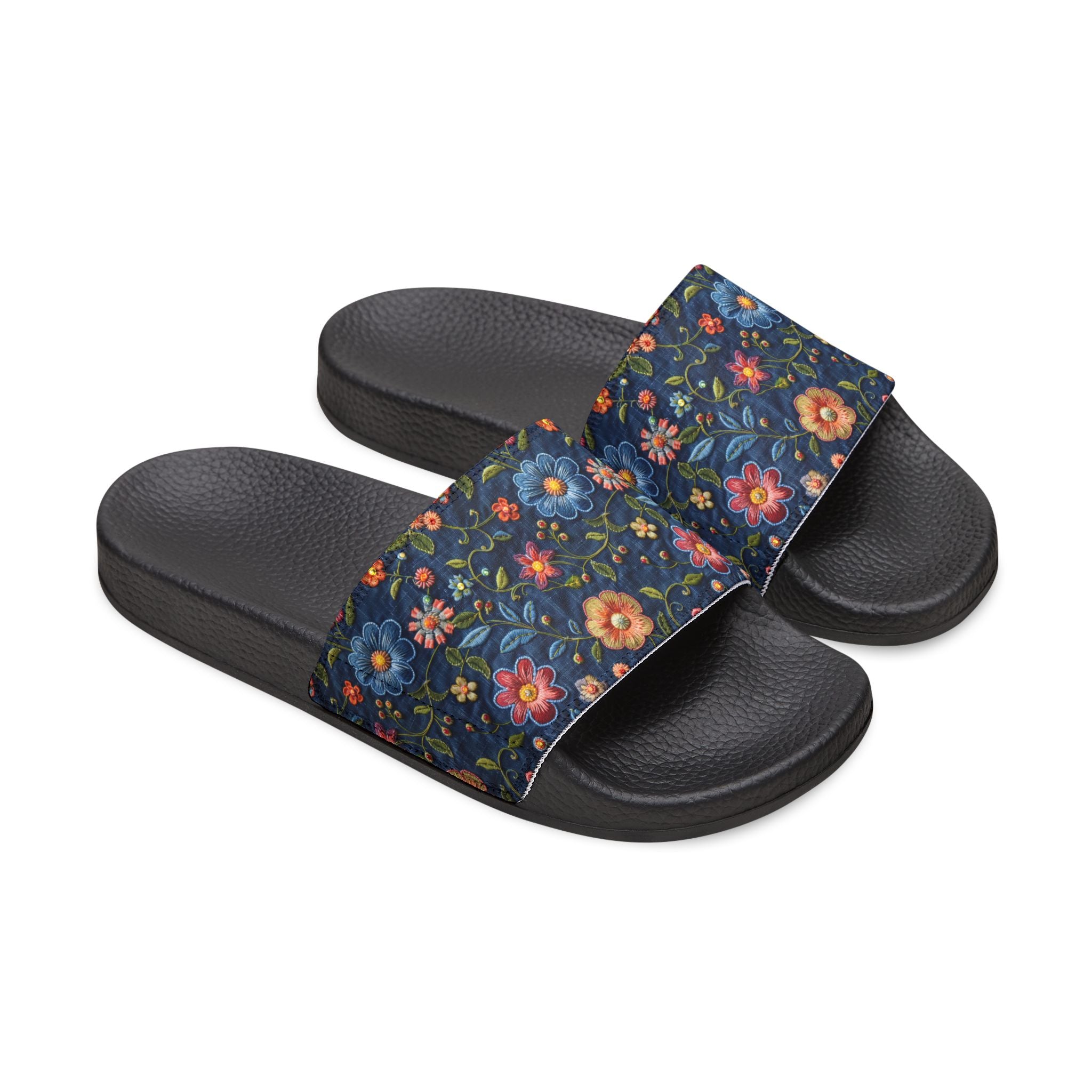 Black slide sandals with floral strap on a white background