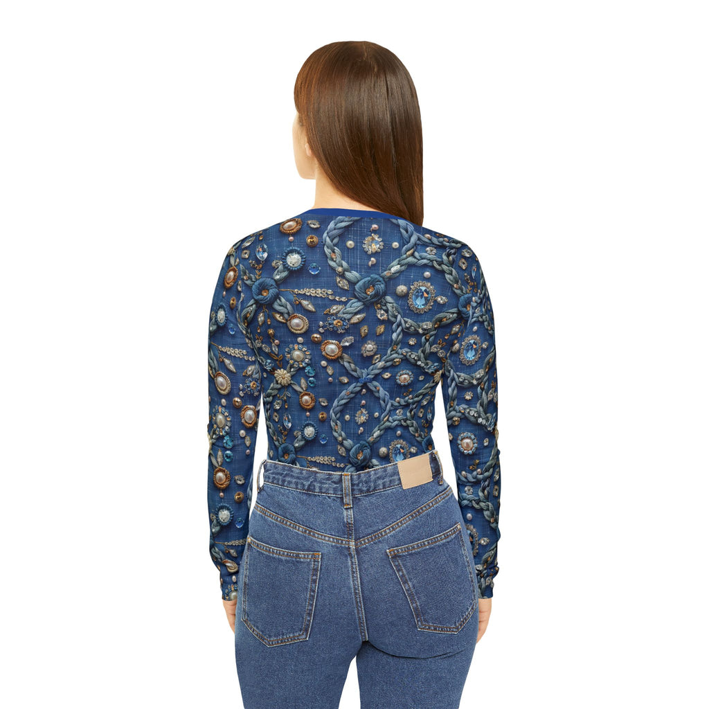 Woman wearing a blue embroidered top and jeans on a white background