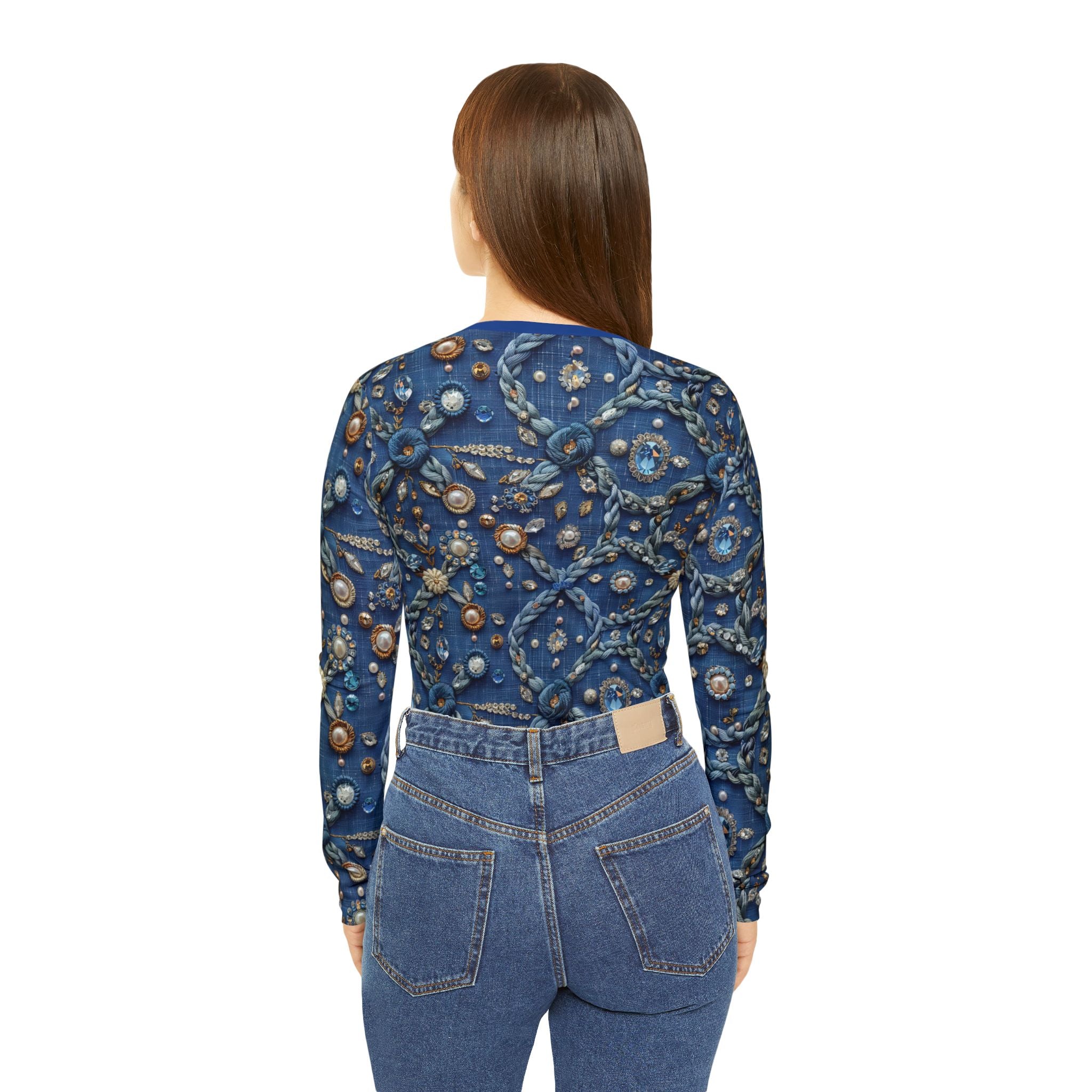 Woman wearing a blue embroidered top and jeans on a white background