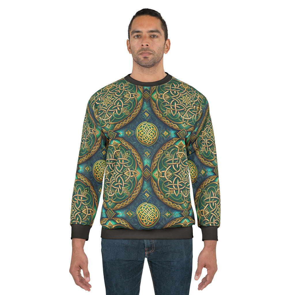 Man wearing a sweater with intricate green and gold patterns on a white background