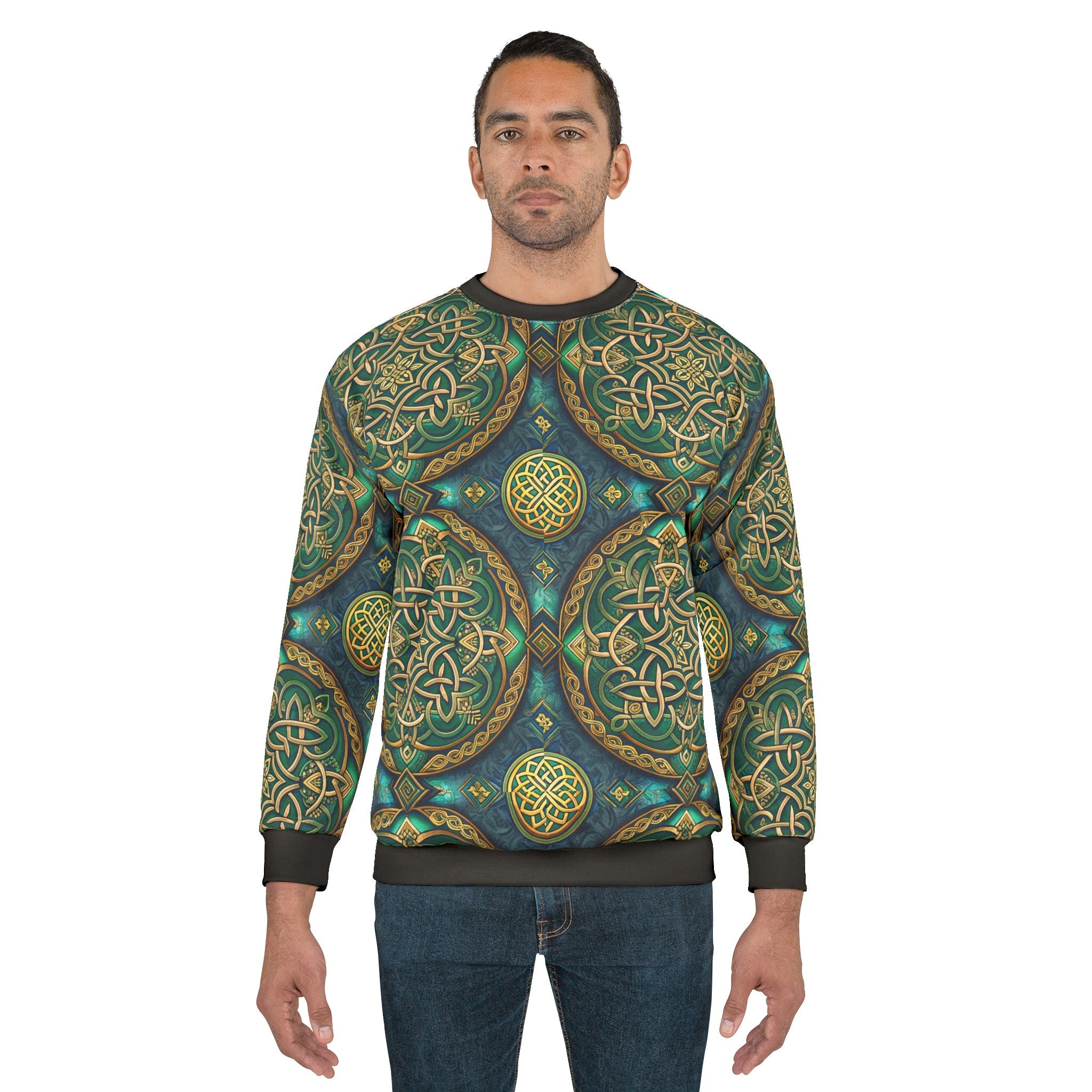Man wearing a sweater with intricate green and gold patterns on a white background