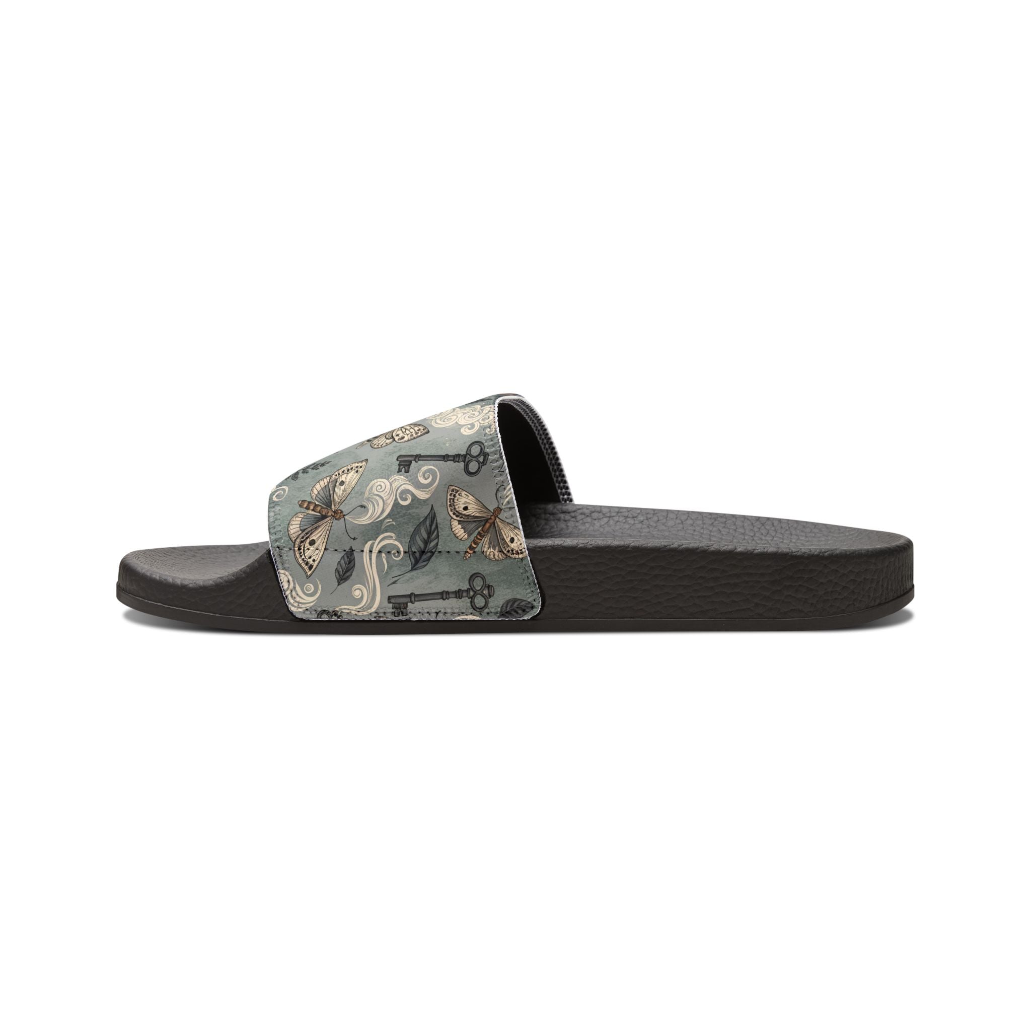 Black slide sandal with a patterned strap on a white background