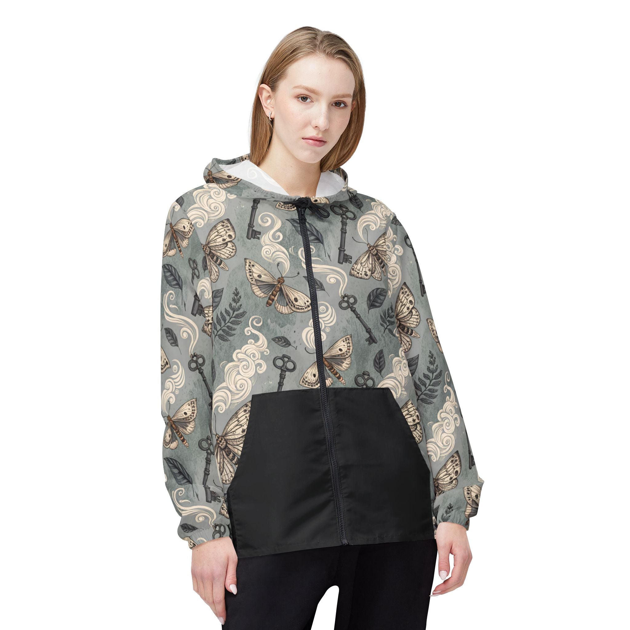 Woman wearing a patterned jacket with keys and butterflies on a white background