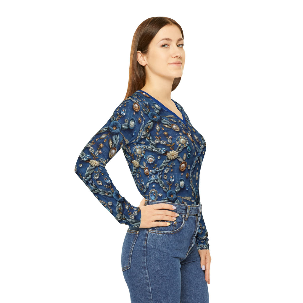 Woman wearing a blue floral embroidered top and jeans on a white background