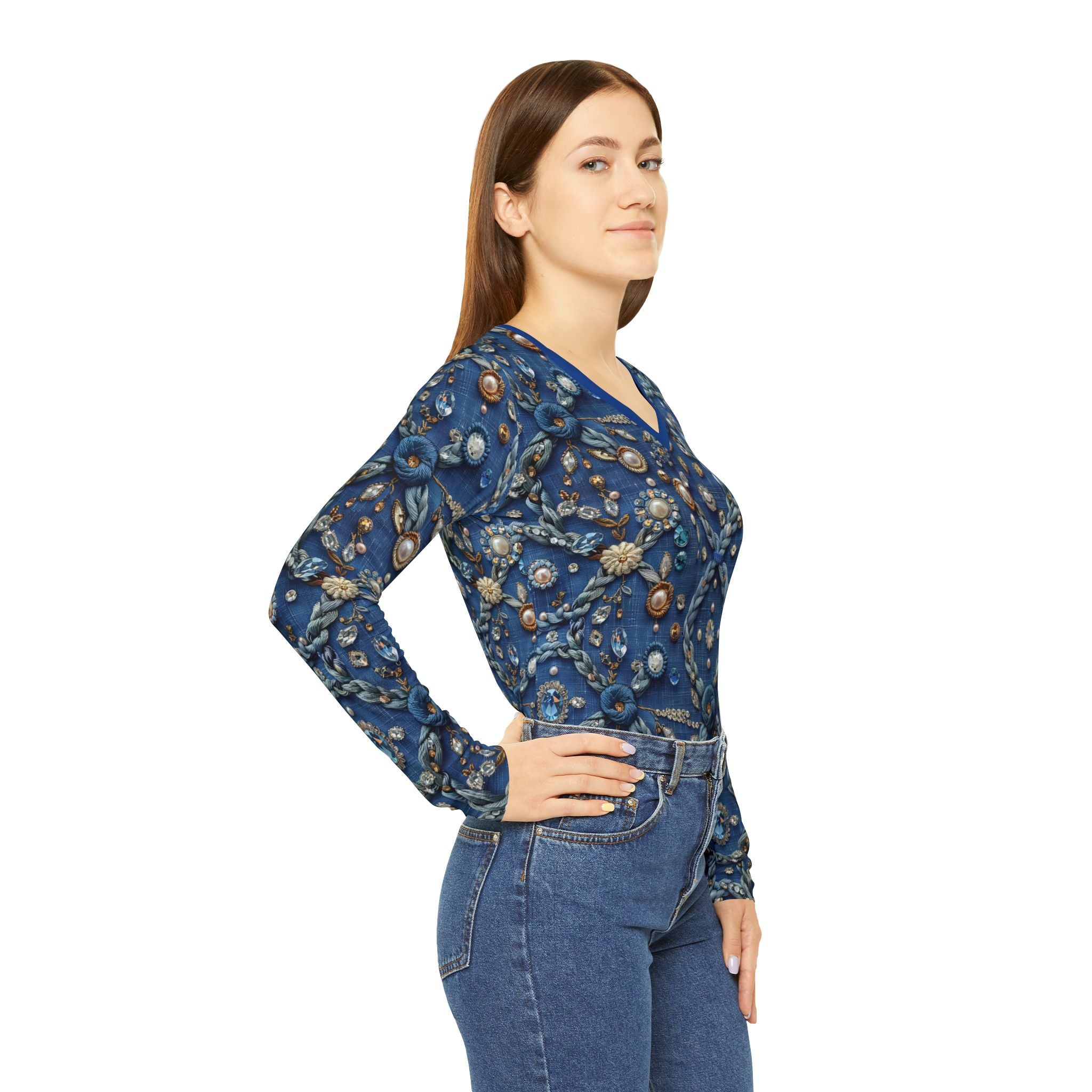 Woman wearing a blue floral embroidered top and jeans on a white background