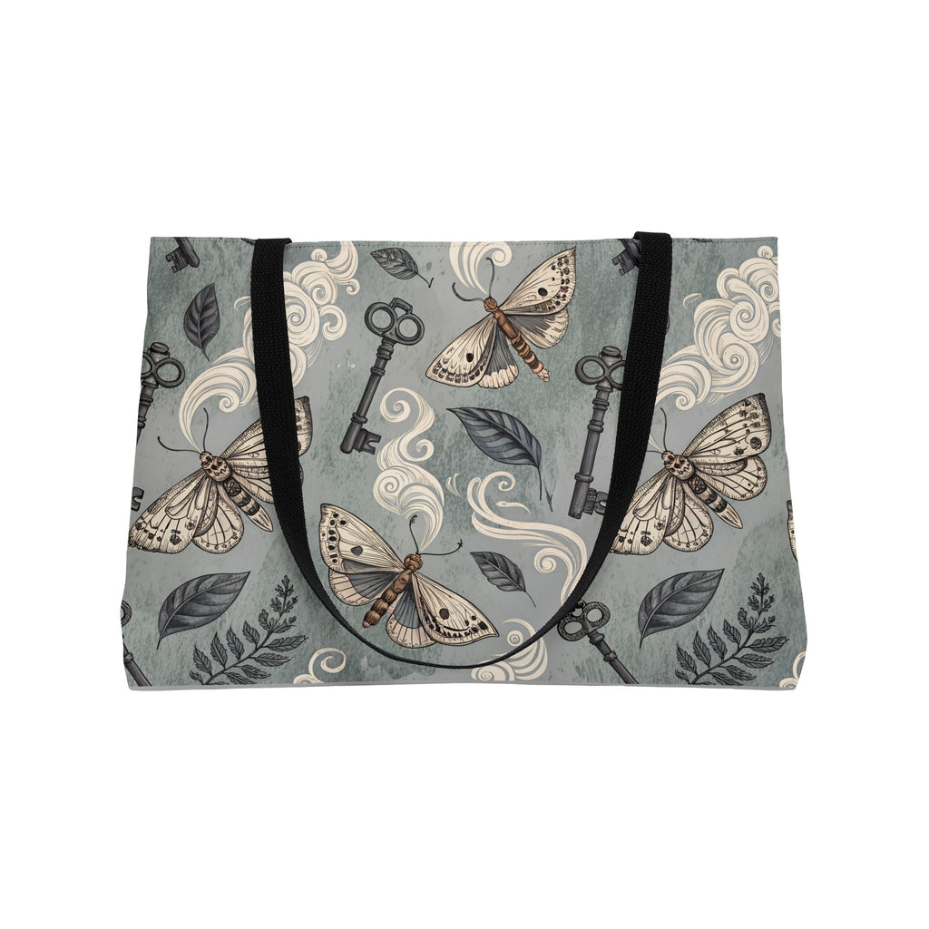 Tote bag with moth and key pattern on a gray background