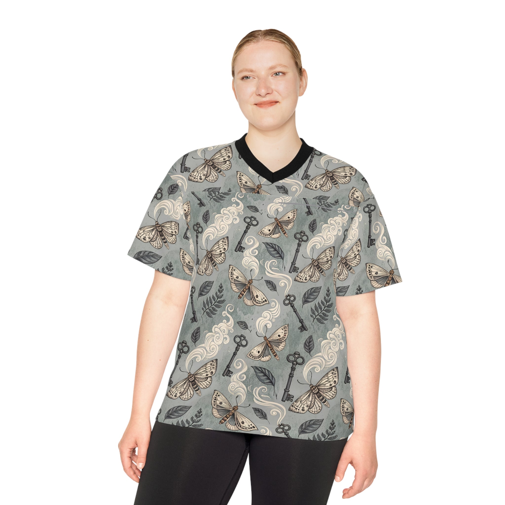 Person wearing a patterned shirt with keys and moths on a white background