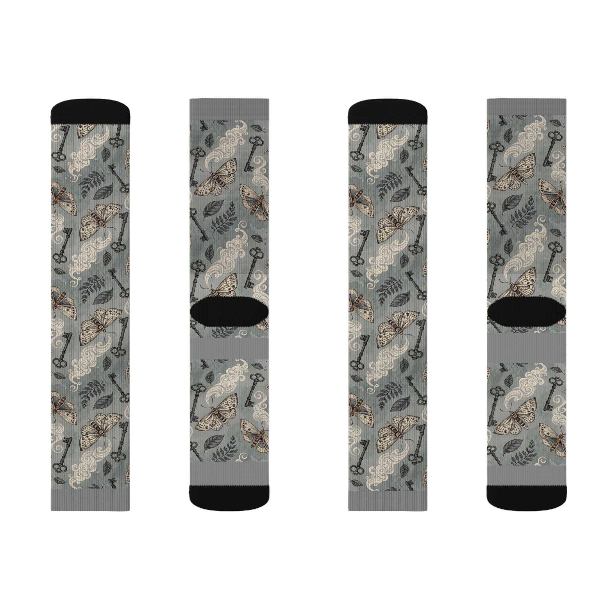 Four socks with a pattern of keys and moth on a gray background