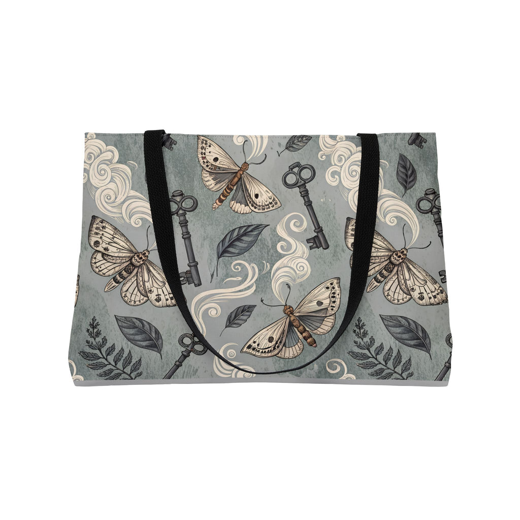 Tote bag with moth and key pattern on a gray background